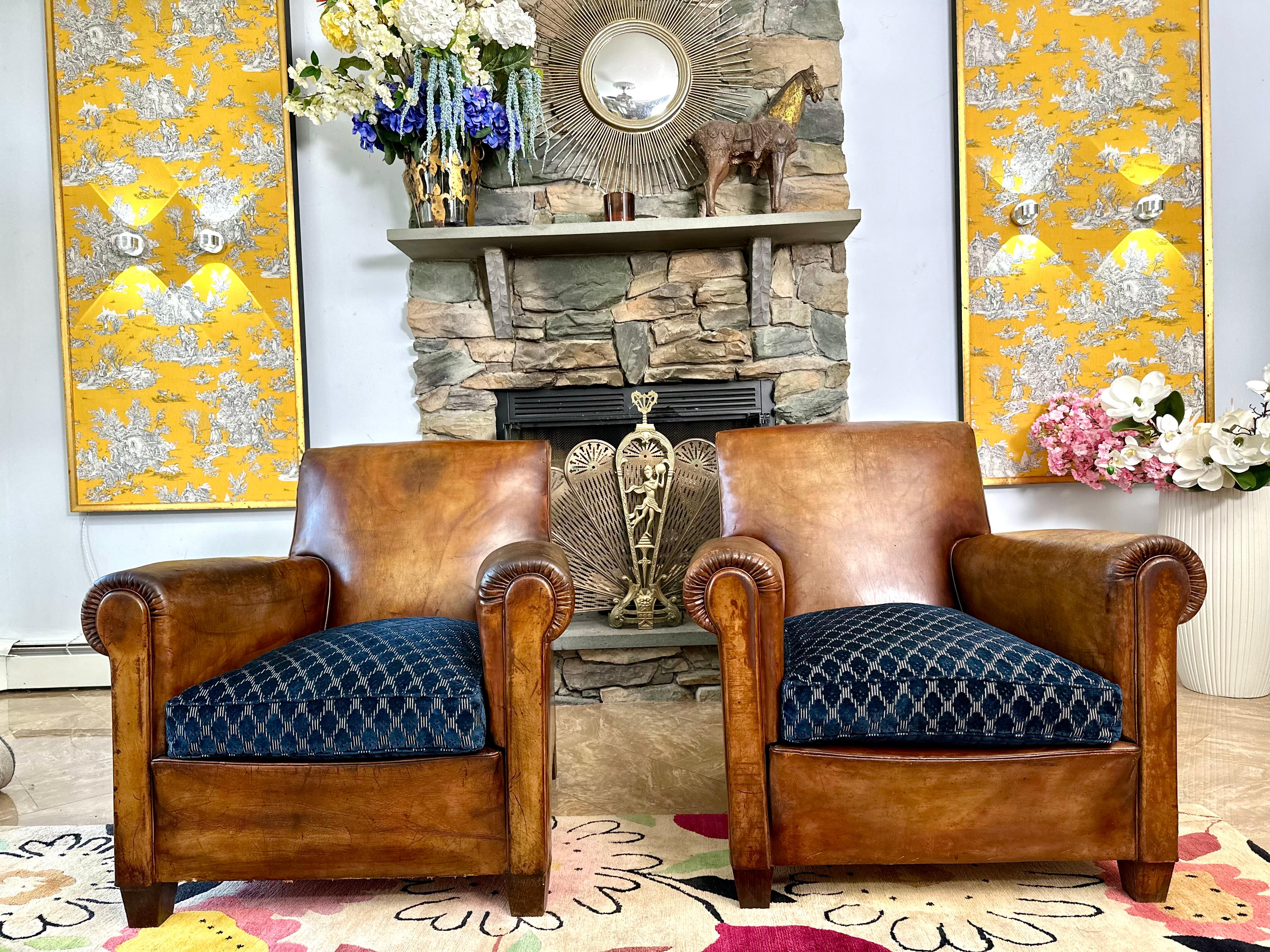 Magnificent pair of Art Deco French leather club chairs - circa 1930's with spectacular soft and supple original leather. This is a beautiful, highly coveted model clubs pair with a lot of character and charm. Recently reupholstered cushions with