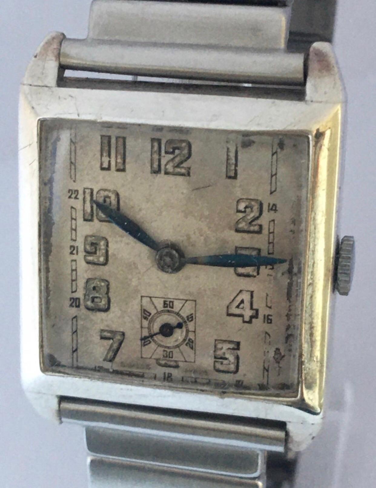 This beautiful pre-owned silver mechanical watch is in good working condition and it has been serviced. Its stainless steel flexible strap is 7 inches long. Visible signs of ageing and wear with slight scratches and tiny dents on the silver watch