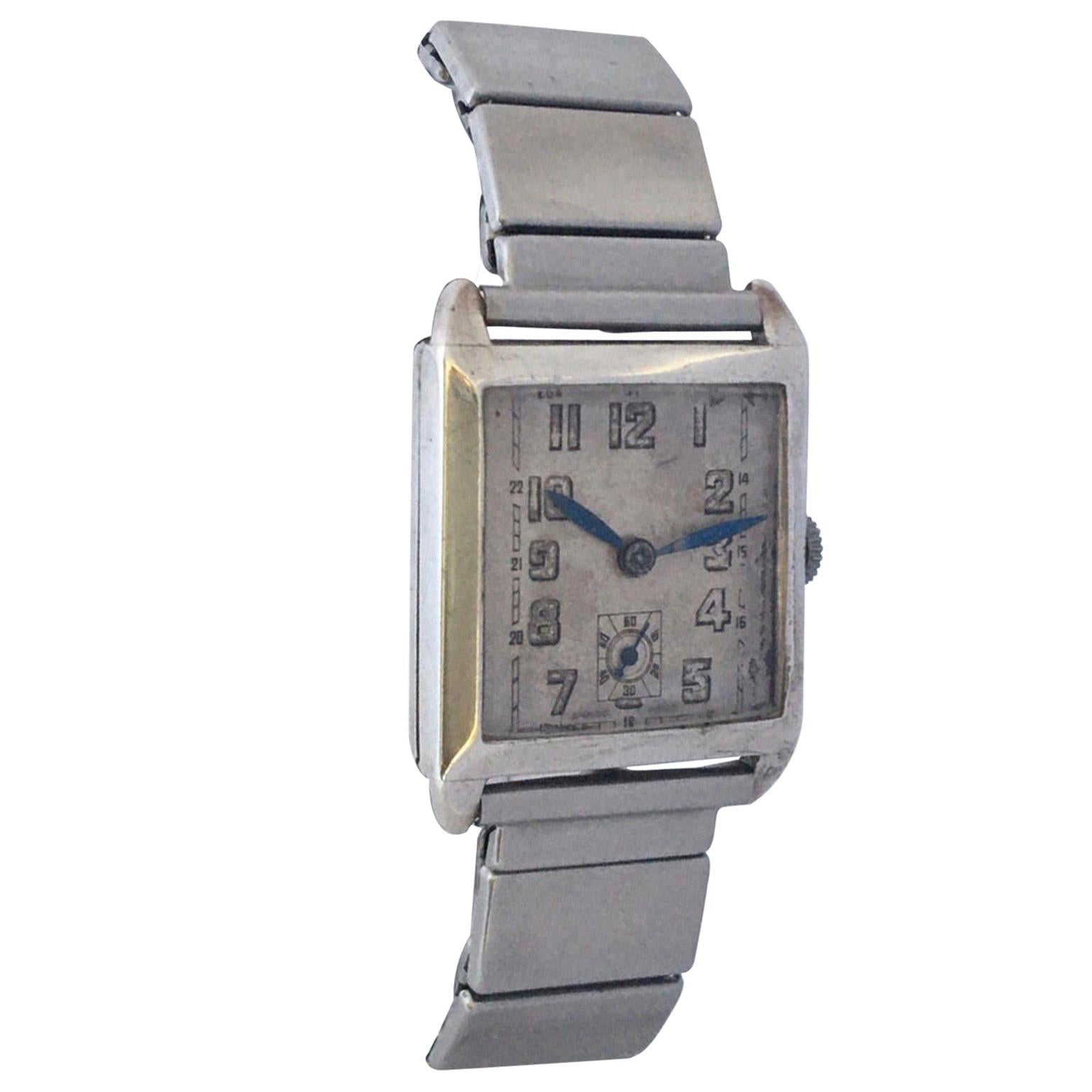 This beautiful pre-owned silver mechanical watch is in good working condition and it has been serviced. Its stainless steel flexible strap is 7 inches long. Visible signs of ageing and wear with slight scratches and tiny dents on the silver watch
