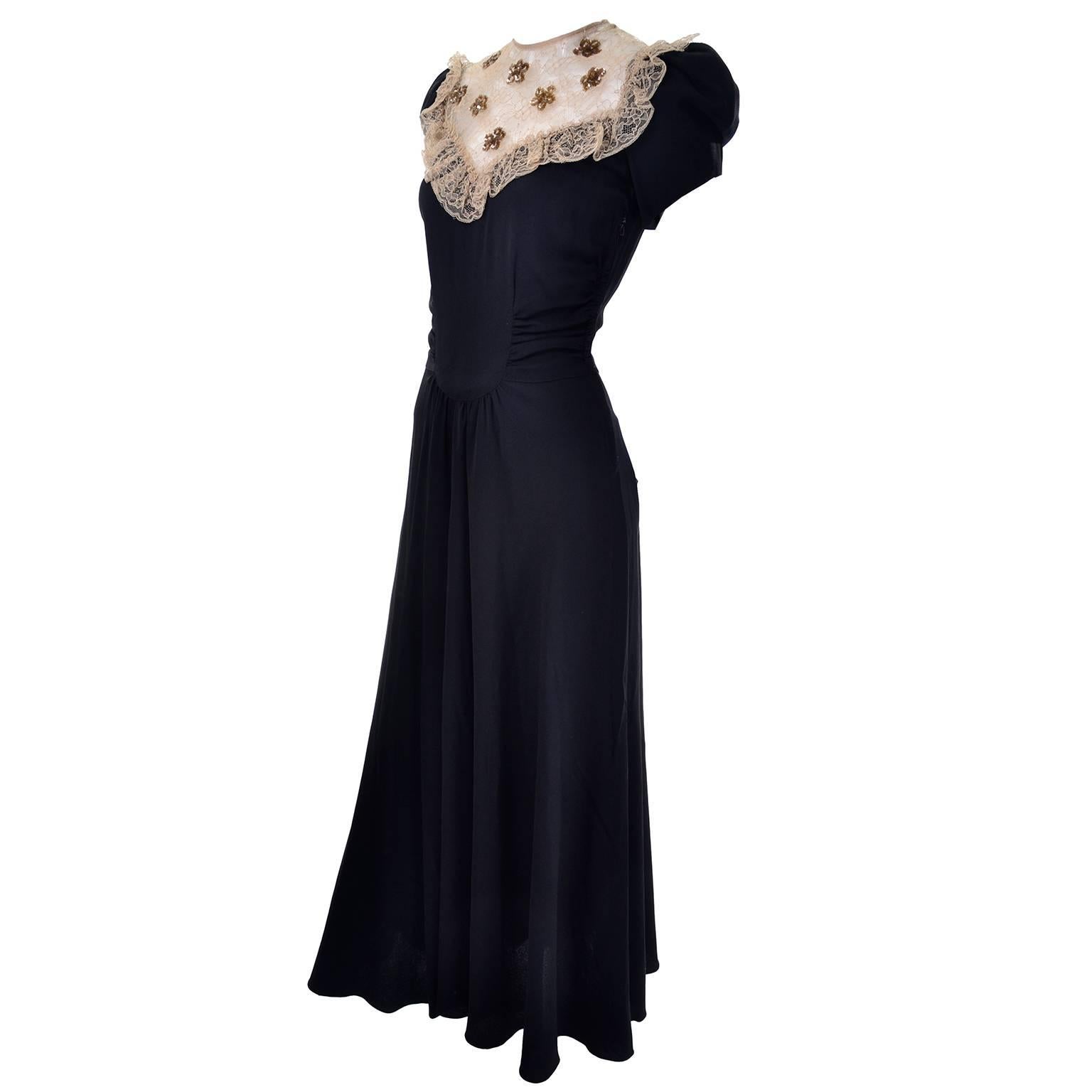 We love the 1930's and this is a wonderful vintage full length black evening dress from the late 1930's.  This feminine evening gown is in a luxurious black rayon crepe with a lovely bodice that features fine gold lace netting and gold sequins