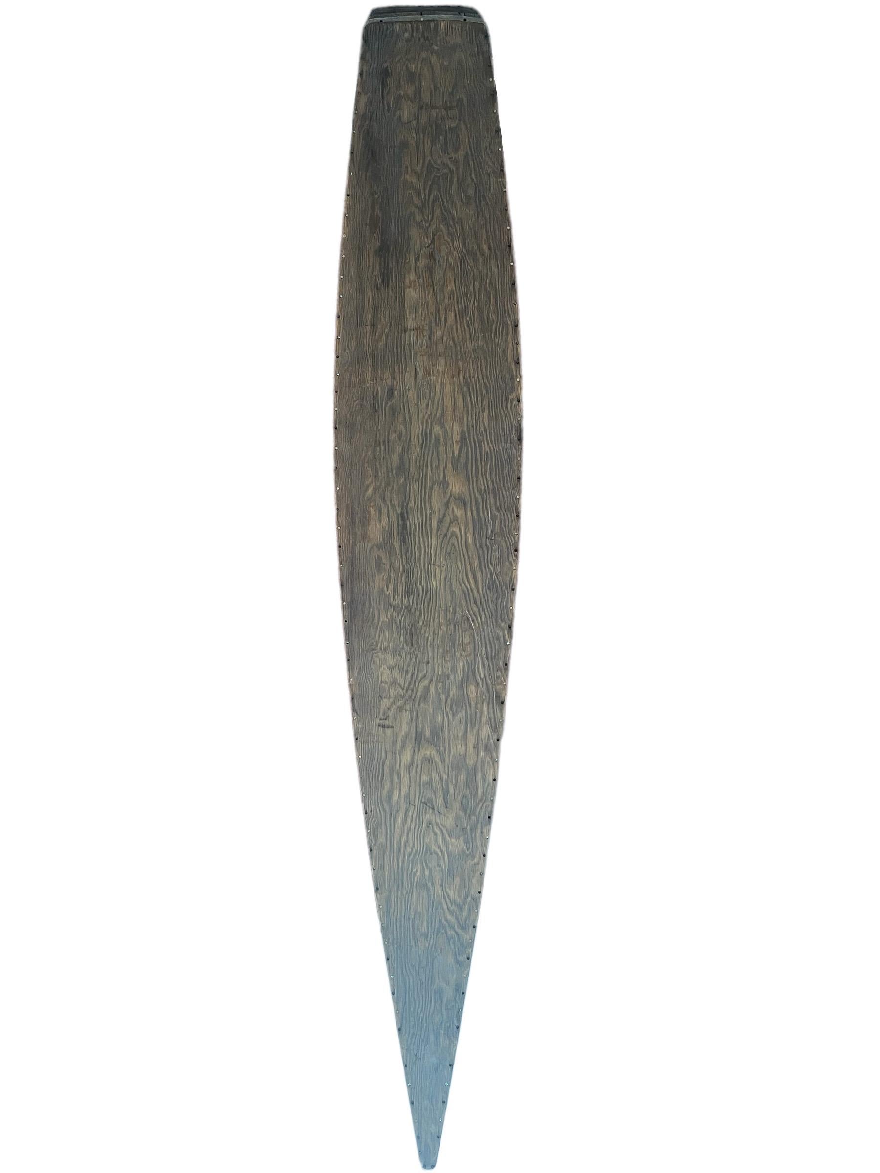 Mid-late 1930s “Kookbox” hollow wood surfboard. Features wood panels joined by metal fasteners and cork water-plug. Patented interior ‘Skin and Frame’ construction method, inspired by the design of airplane wings. This breakthrough surfboard