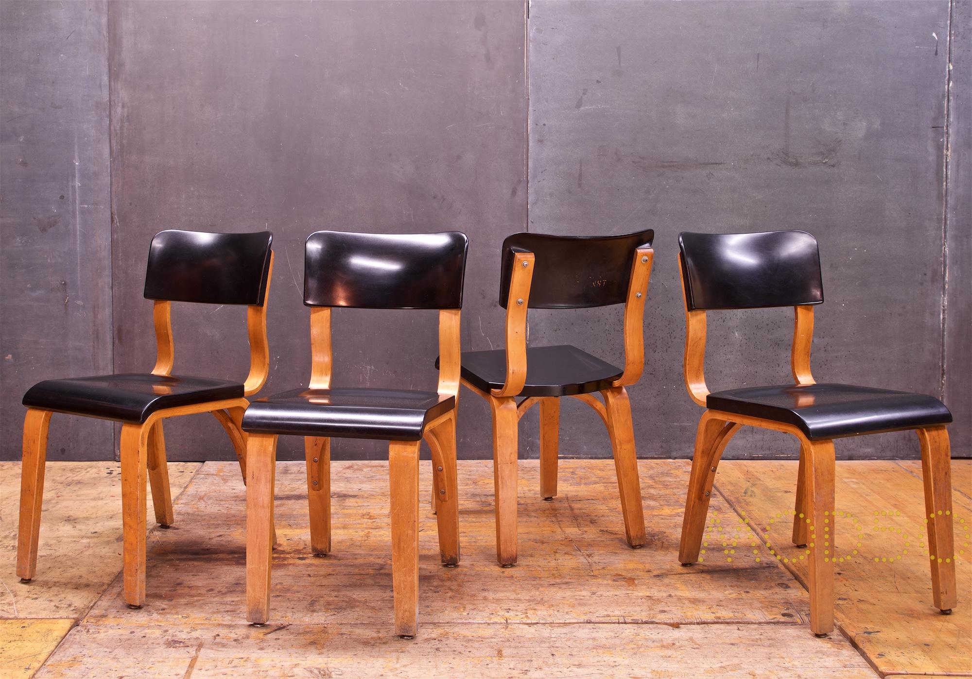 A set of 4 side chairs, in black bakelite. All functional strong and usable. Showing some wear.