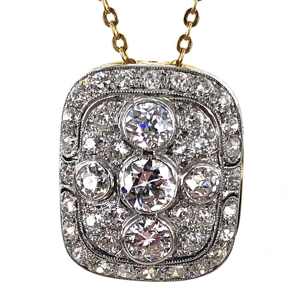 Vintage diamond pendant crafted in platinum and yellow gold. The pendant features 41 Old European Cut Diamonds weighing approximately 1.50 carat total weight. The diamonds are graded G-H color and VS clarity. The pendant measures 13 x 16mm and is on