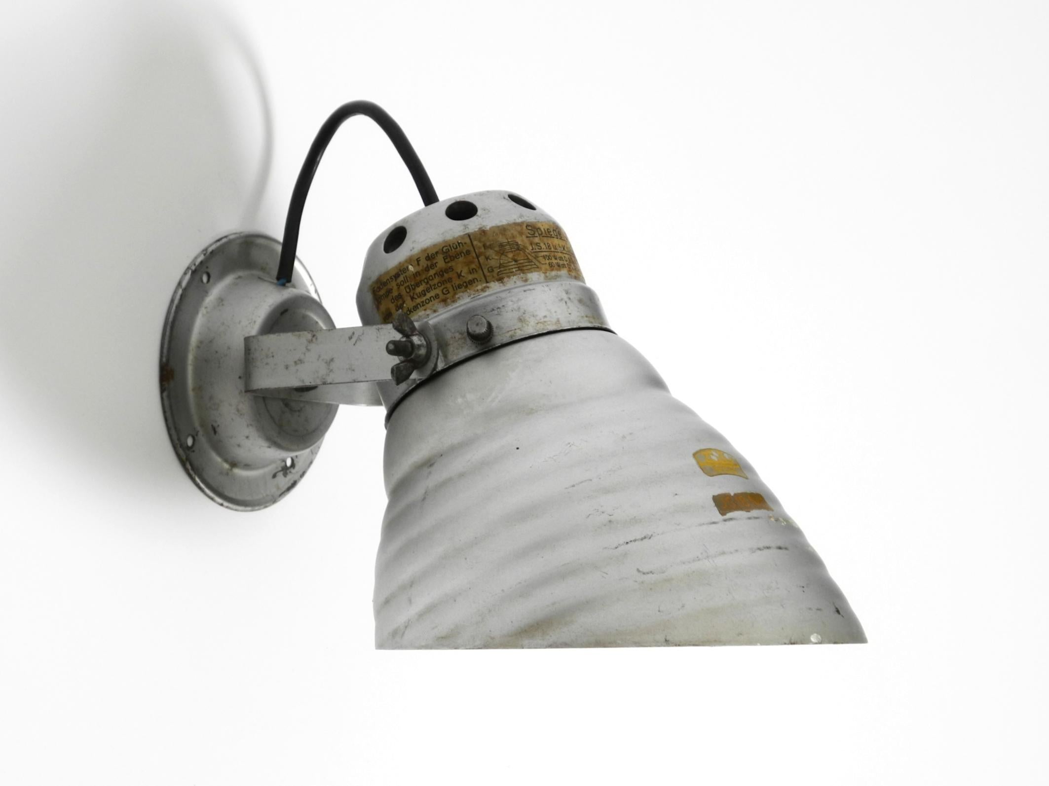 Beautiful 1930s industrial wall or ceiling lamp with a mirrored glass lampshade by Adolf Meyer for Zeiss Ikon with an adjustable shade.
Made in Germany. With the original label on the shade. The shade is removable and adjustable. The frame and