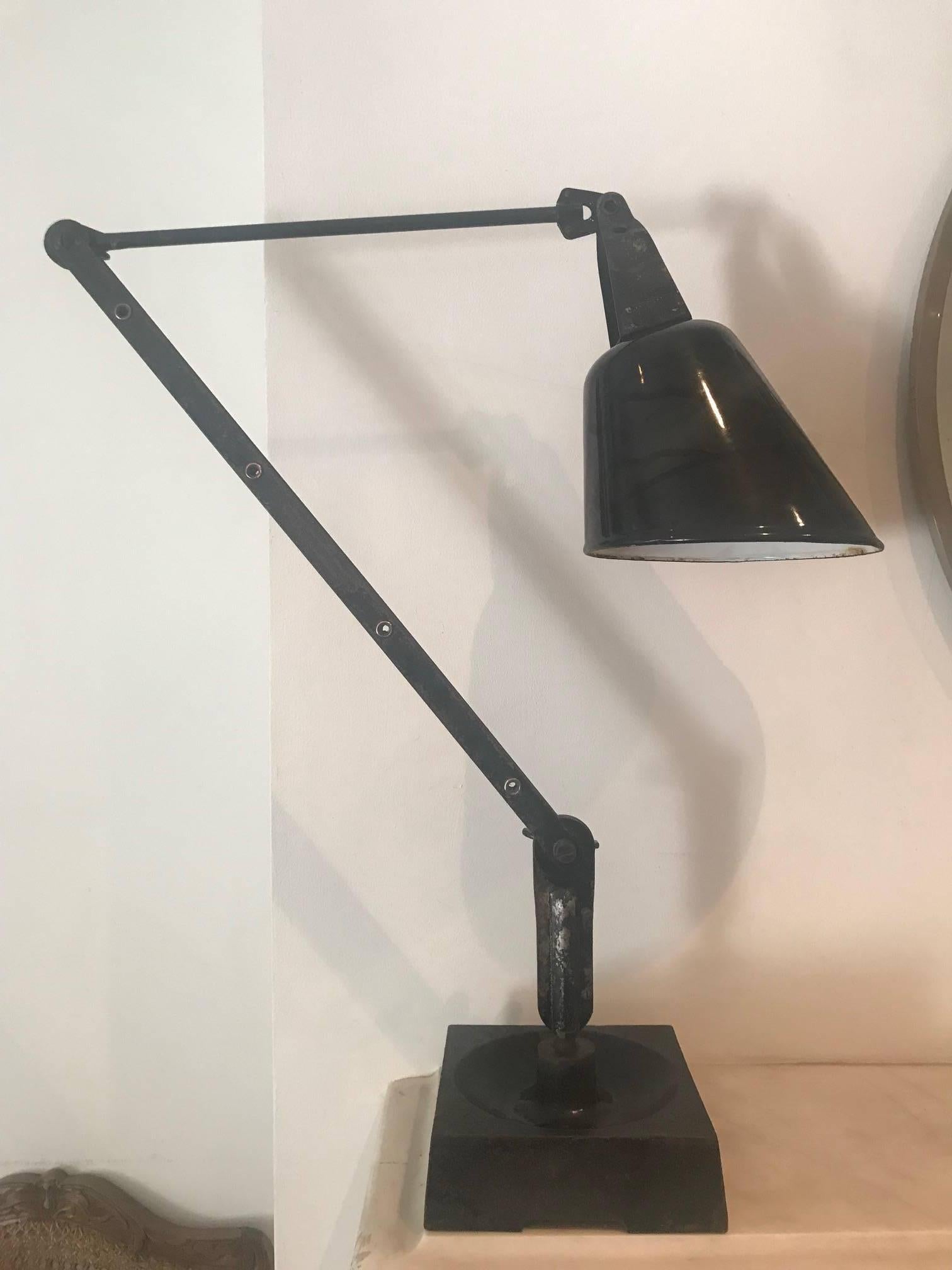 Offered by Caroline de Kerangal an original Walligraph black metal on cast iron base anglepoise desk lamp. English c.1930's. Original shade. Can be sold as is or rewired. It is adjustable so the measurements are approximate.