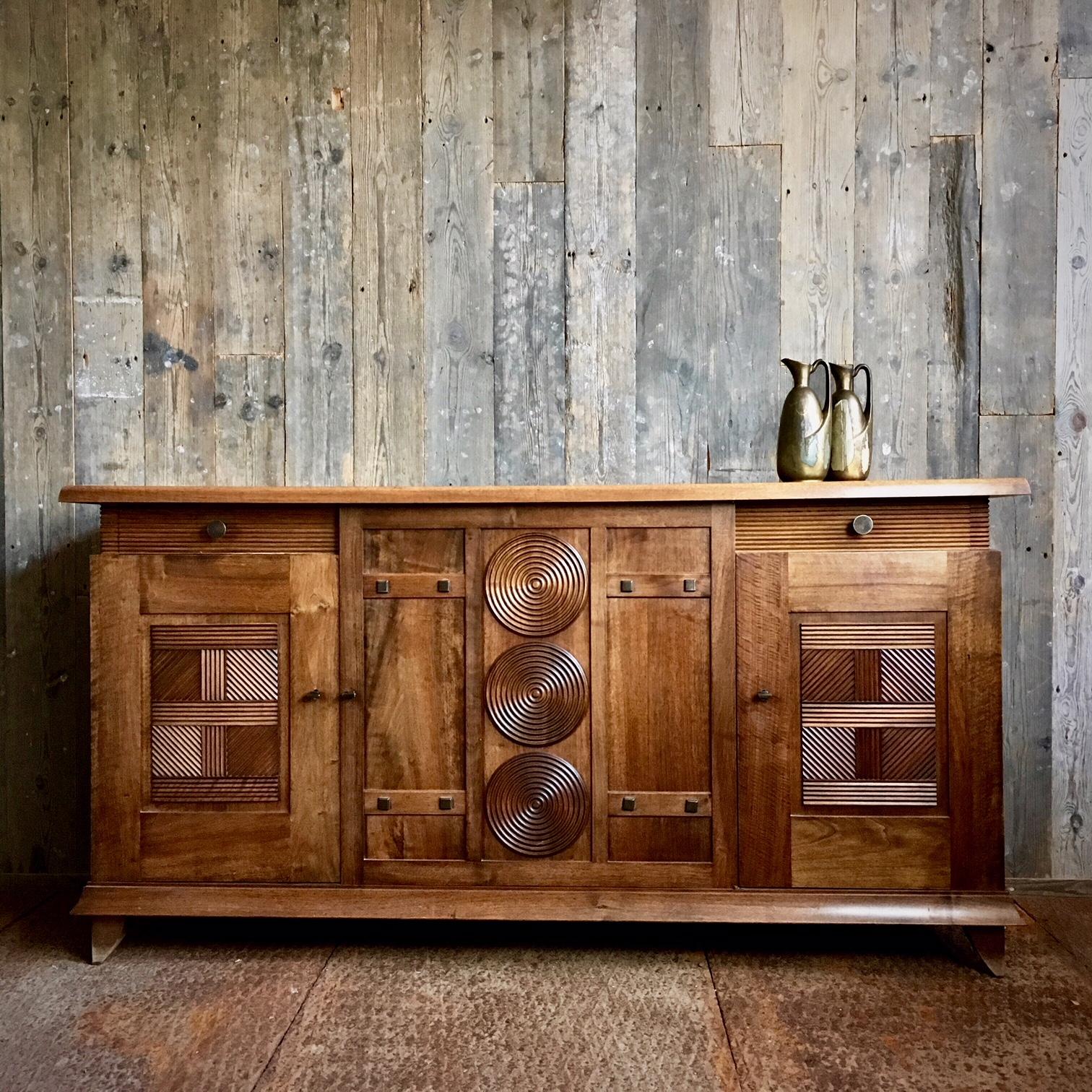 Beautiful walnut sideboard by the French designer Charles Dudouyt. The cabinet was made in the 30s and is a fine example of a progressive, clean and modern style, but influenced by Art Deco and the Arts and Crafts movement. 

The cabinet has three