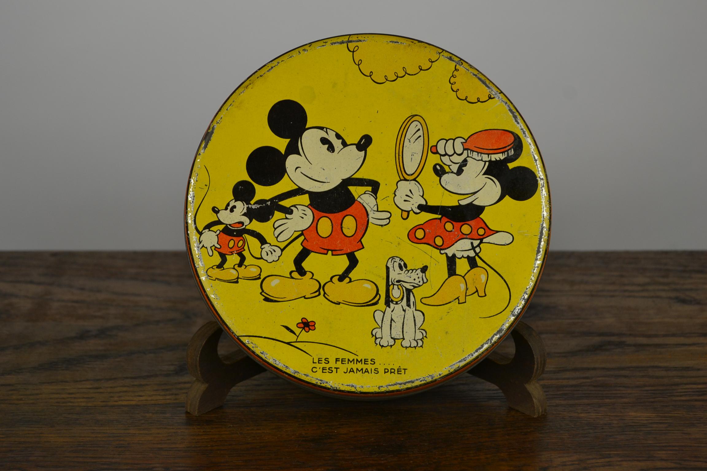 Rare Antique Lithographic Walt Disney Biscuit Tin - Lunch box - Cookie Tin - Disneyana Tin Container 
Round yellow tin with images of Mickey, Minnie Mouse and Pluto, famous Animation Figures.
It was made to sell  cookies - Biscuits, but could be