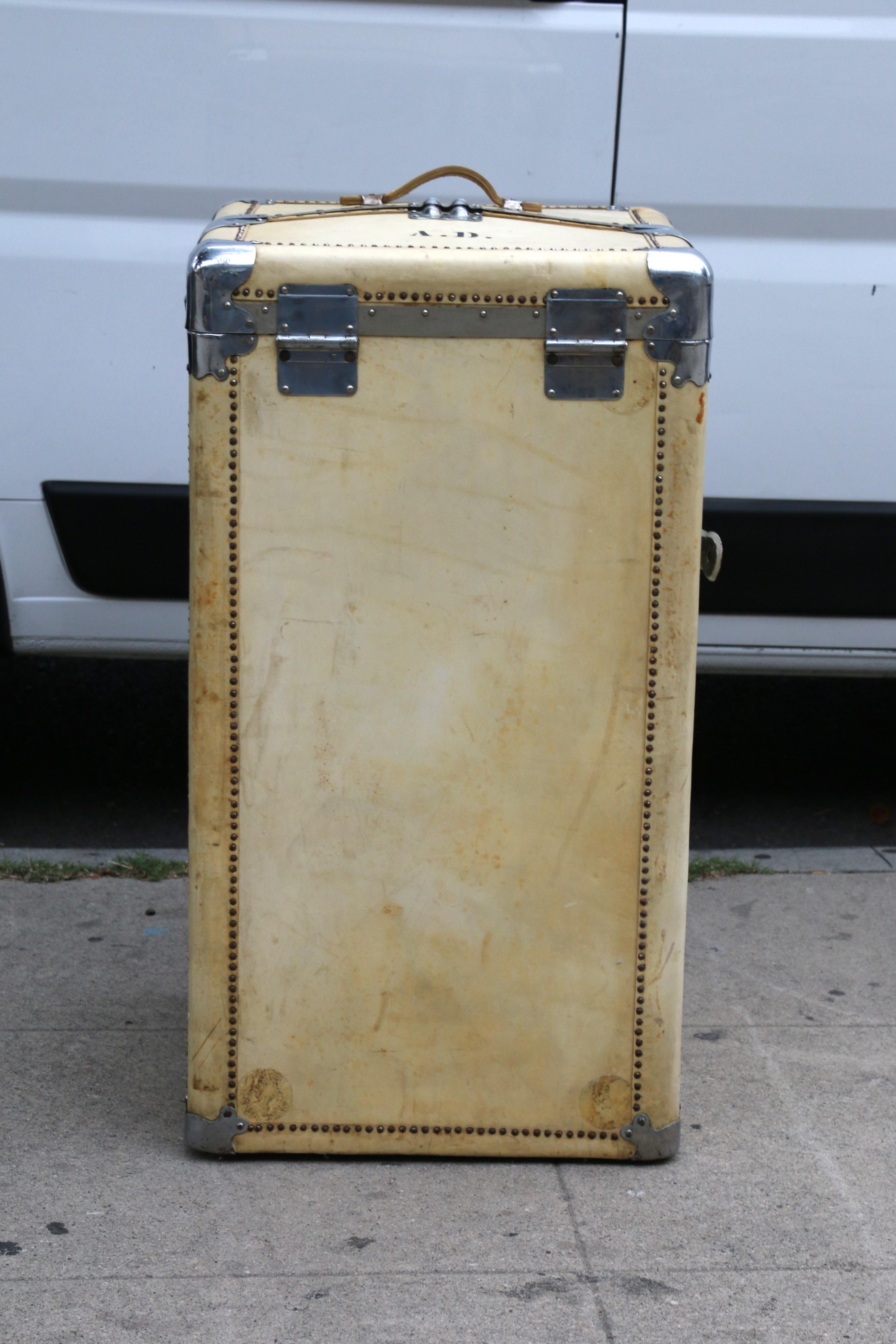 Wonderful rectangular cuboid wardrobe trunk made of coat skin and chrome accents hardware. It is complete and in exceptional gently used condition. It has some wear due to age and used. It includes five drawers and shoe case and assorted shape