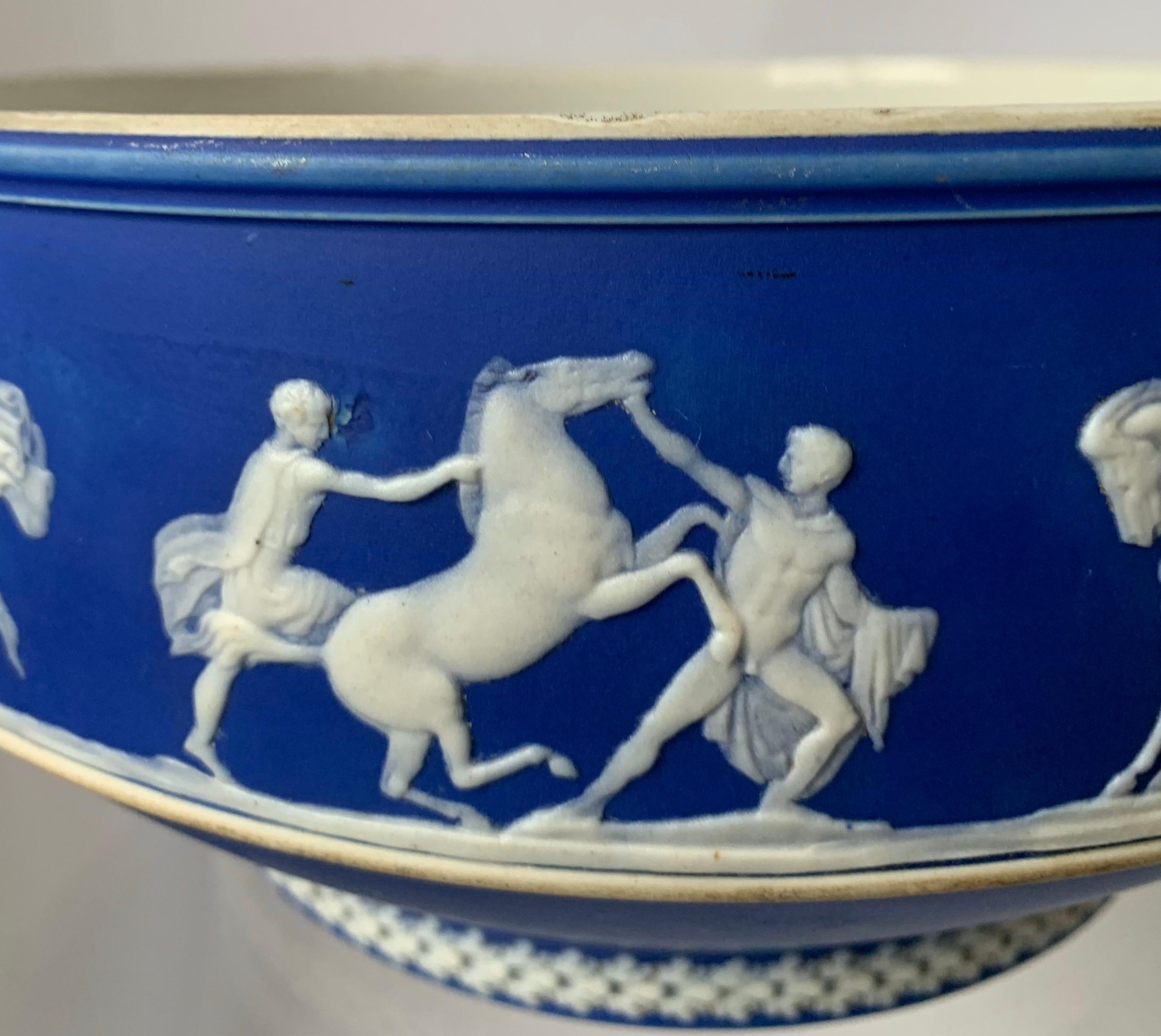 1930s Wedgwood jasperware bowl. Dark blue jasperware with all-over white neoclassical motif. Interior of the bowl is glazed.