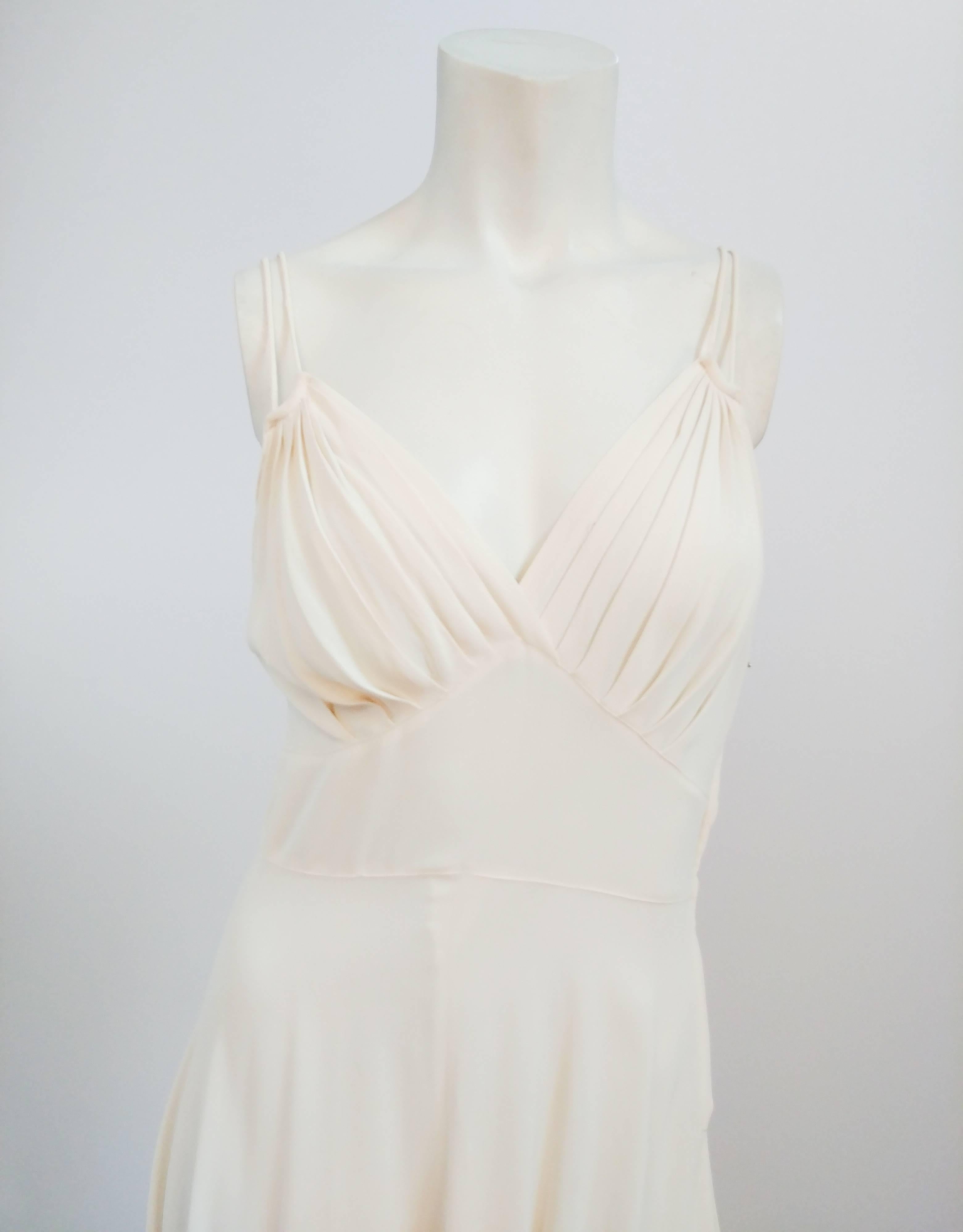 1930s Off-White crepe Double spaghetti Strap Dress. Gathered under the bust cups with inverted basque waist. Gathered at the waist line with a metal size zipper closure. The silhouette of this dress reflects the glamour of 1930s Hollywood.
