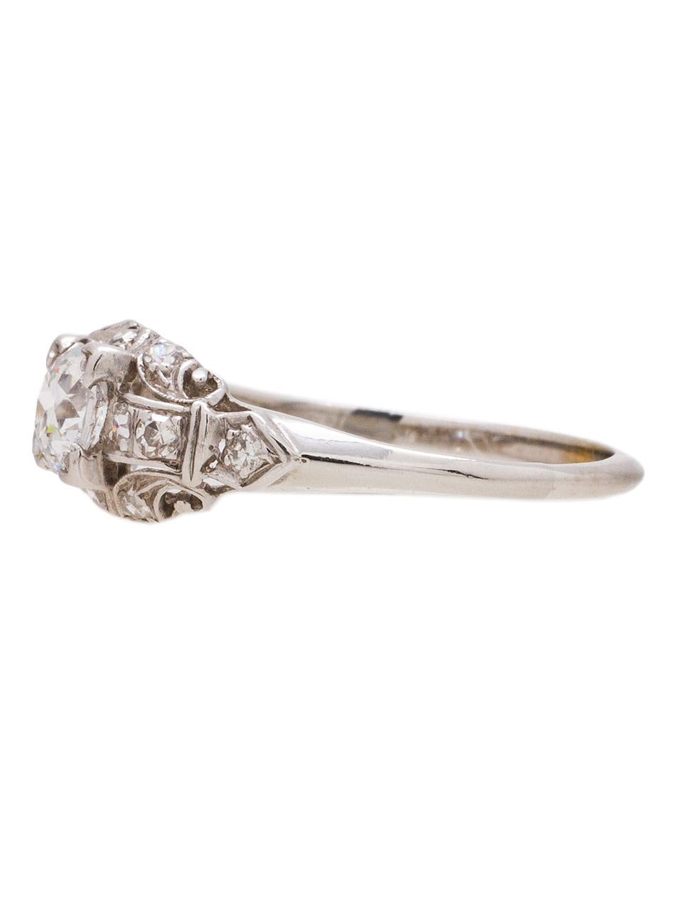 This engagement ring is set in 18k white gold with a beautiful 0.46 carat old European cut diamond, H color and VS2 clarity. With 12 accent diamonds adding 0.24 carat. Nice detail with open work with scroll design. Precious and unique ring. Size