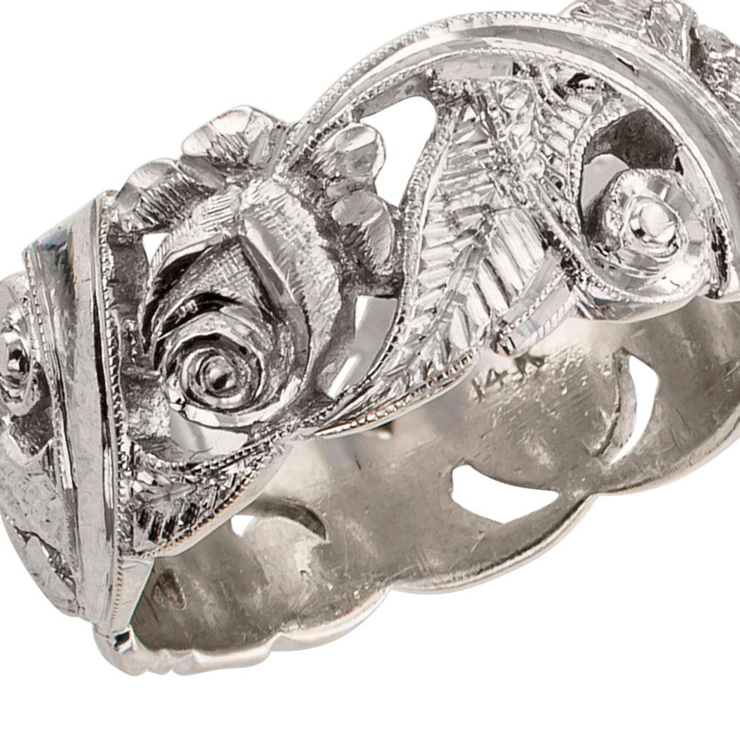 Vintage 1930s rose garland white gold wedding band. Designed as garland of roses to wrap around the finger, the open work ring band features a lush arrangement of roses and foliage all highlighted by crisp tooling details on the white gold. It is