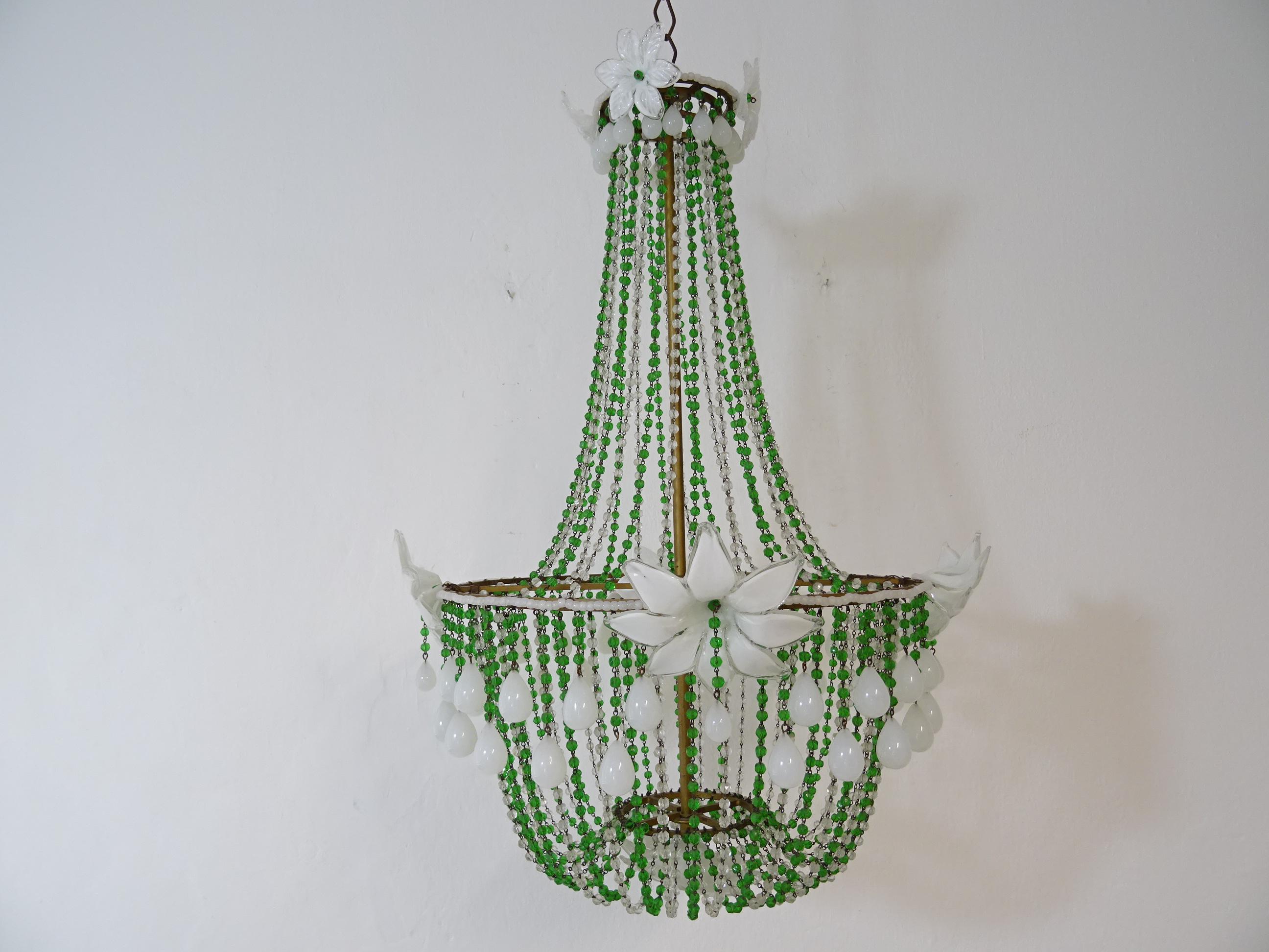 Housing 4 lights, will be rewired with certified UL US sockets for the Unites States and appropriate sockets for all other countries and ready to hang. One of a kind green and clear crystal swags with white opaline beads. Adorning 8 Murano flowers