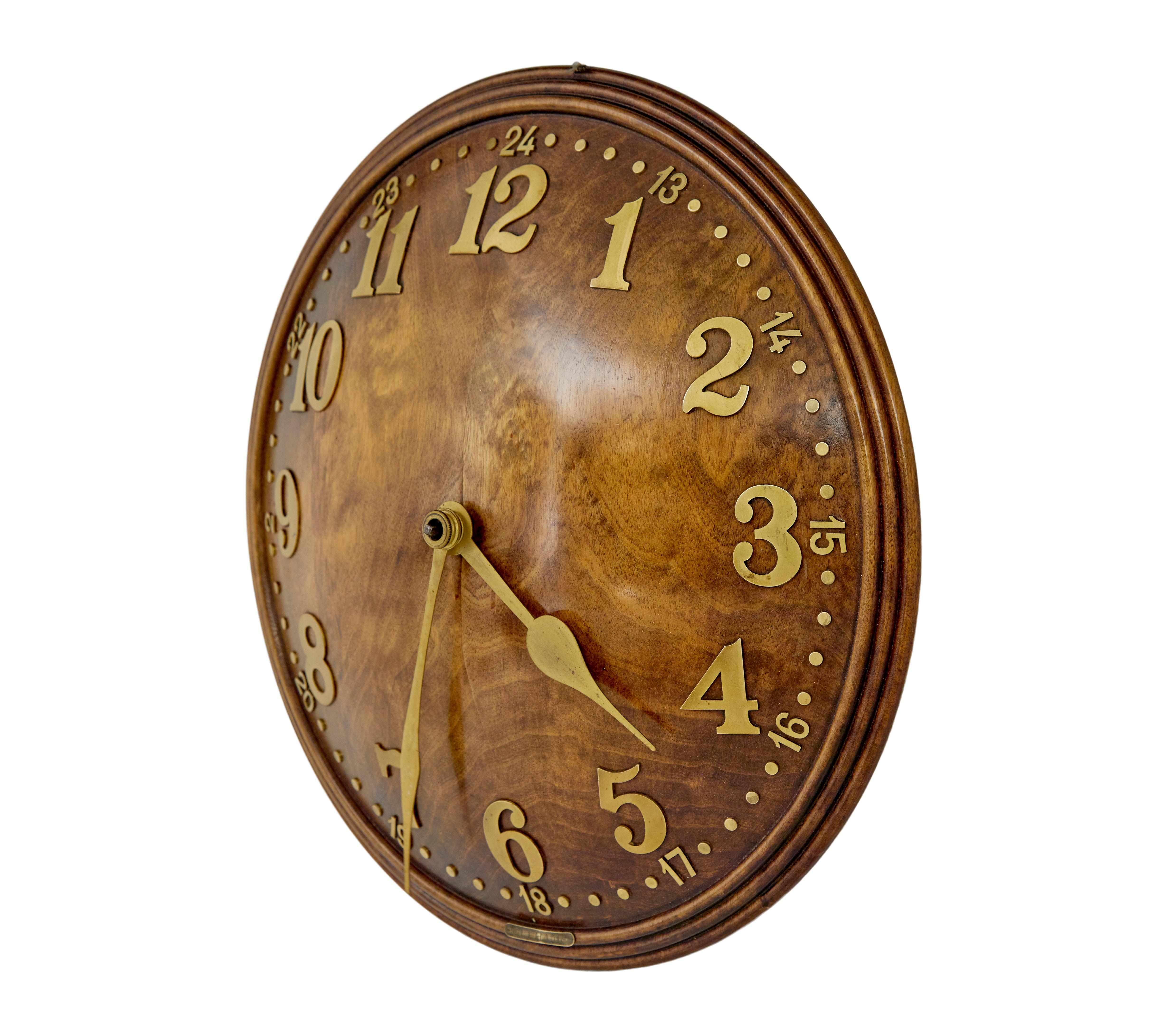 1930's wood and brass convex wall clock by zenith circa 1930.

Well known art deco swiss made wall clock retailed by heal’s in the 1930’s. Convex shaped round clock face with moulded edge. Decorated with applied brass numerals and hands.

Fitted