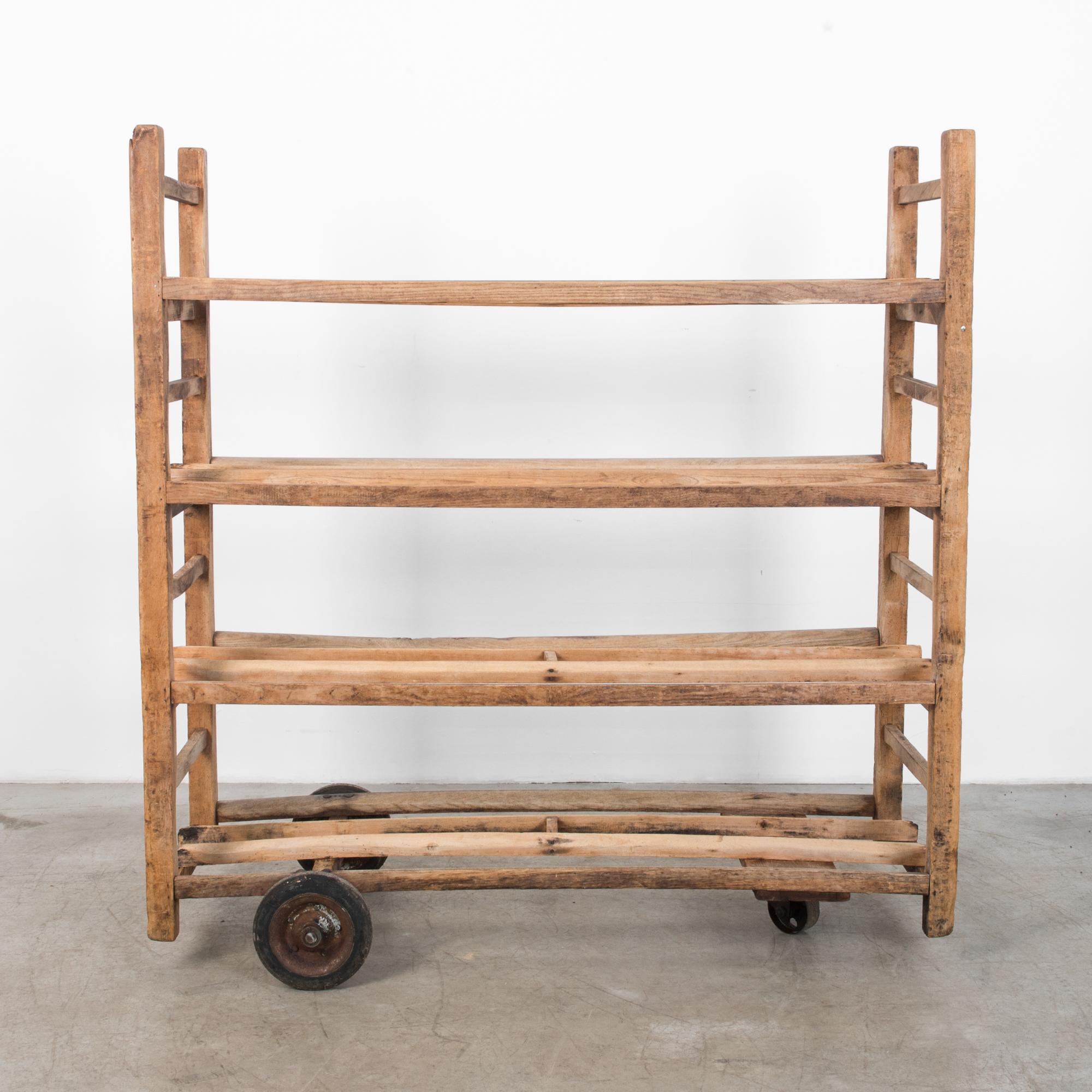 This rustic trolley was used for storage and transport in a French bakery. Great natural finish. With practical wheels and sturdy wooden construction, this piece is full of rustic European charm, cleaned and prepared for your home.