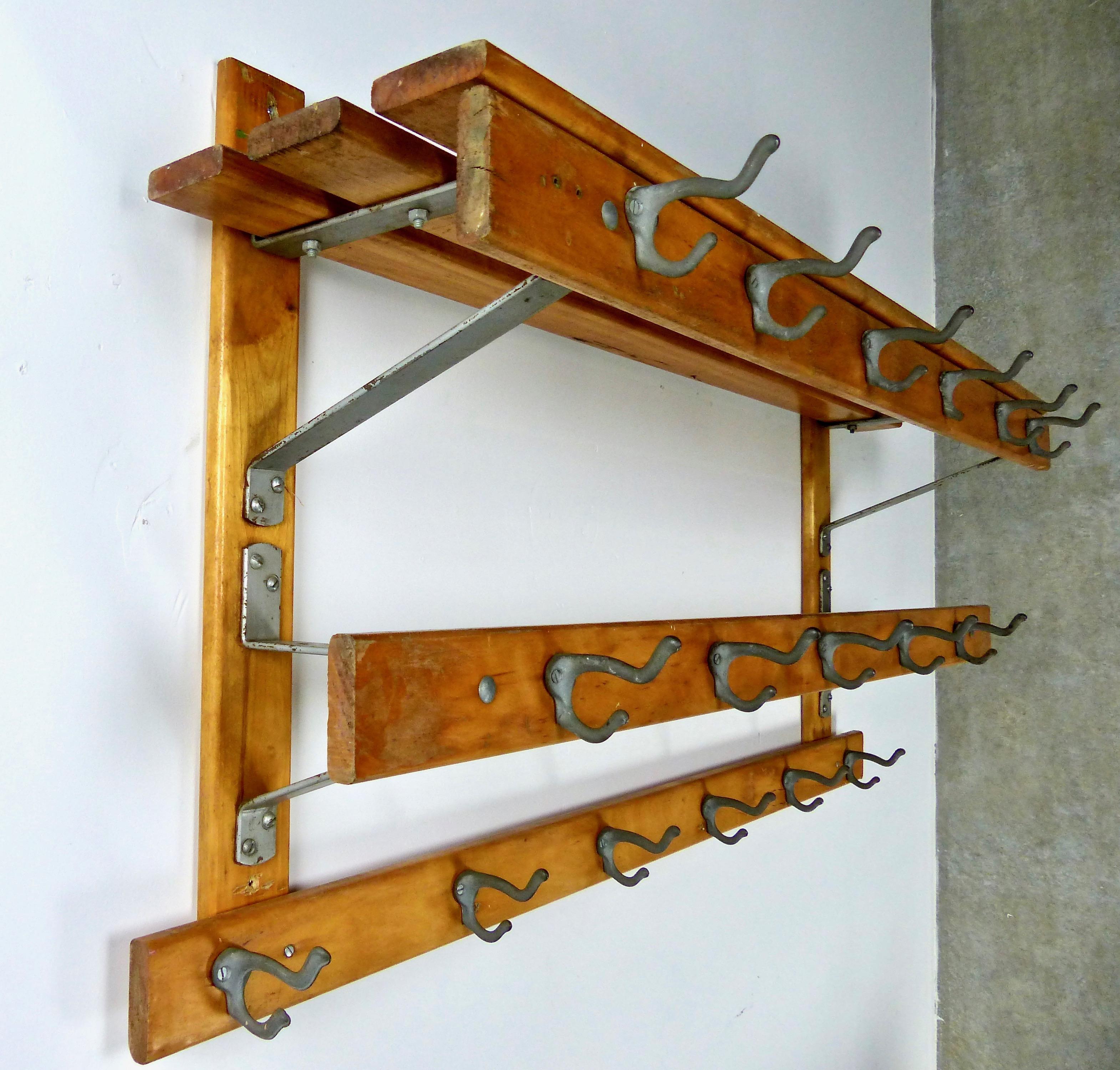 Well-built and sturdy oak hall rack with both slat shelves and original metal hooks.
 Excellent authentic storage unit for a country entryway, mudroom etc. 
Salvaged from a school in Upper NY.