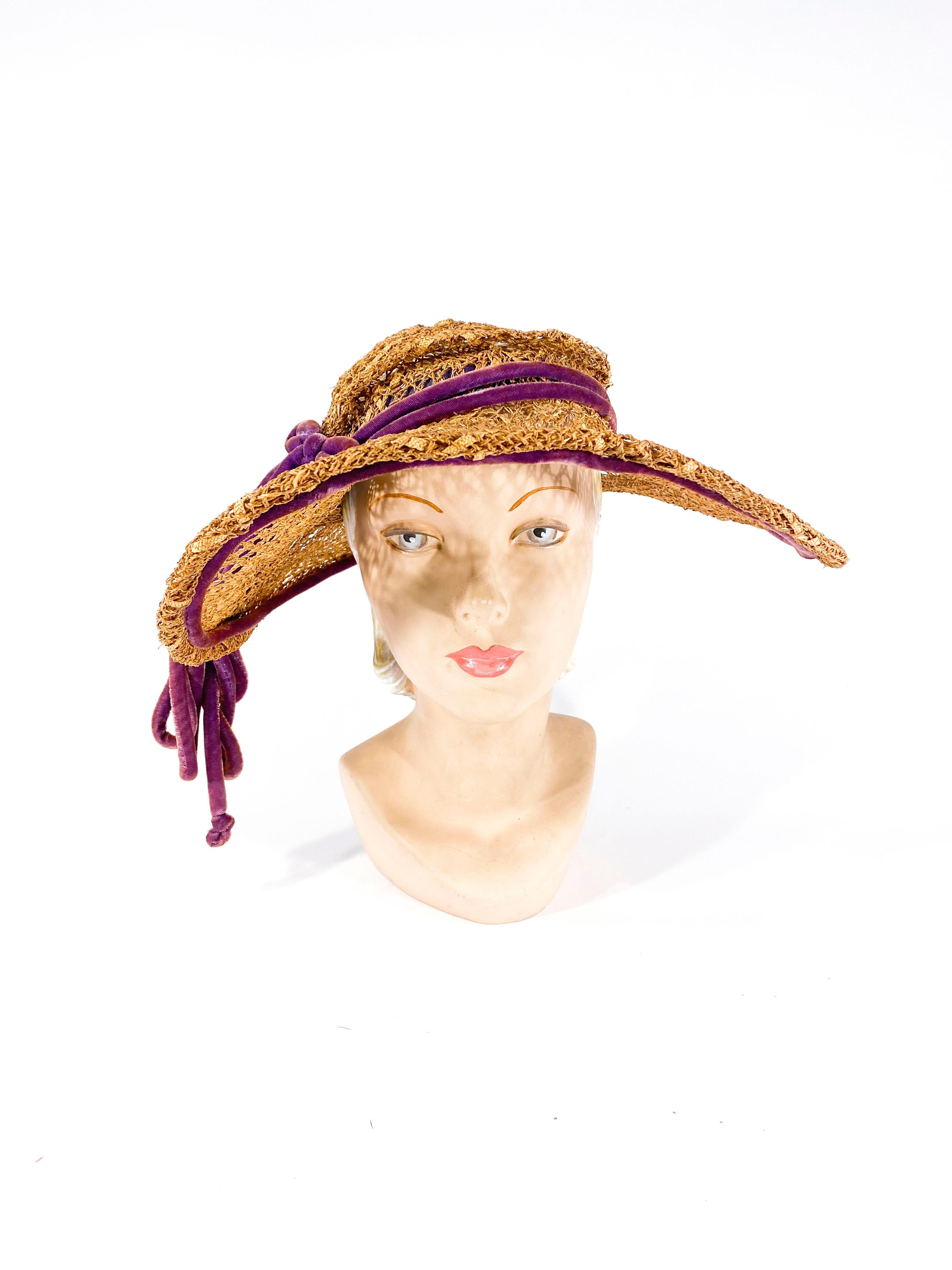 1930s handwoven straw picture hat that is unlined and meant to be worn in the summer. The wide brim is wired and the hat is finished with a hand made light purple velvet cord band and oversized bow.
