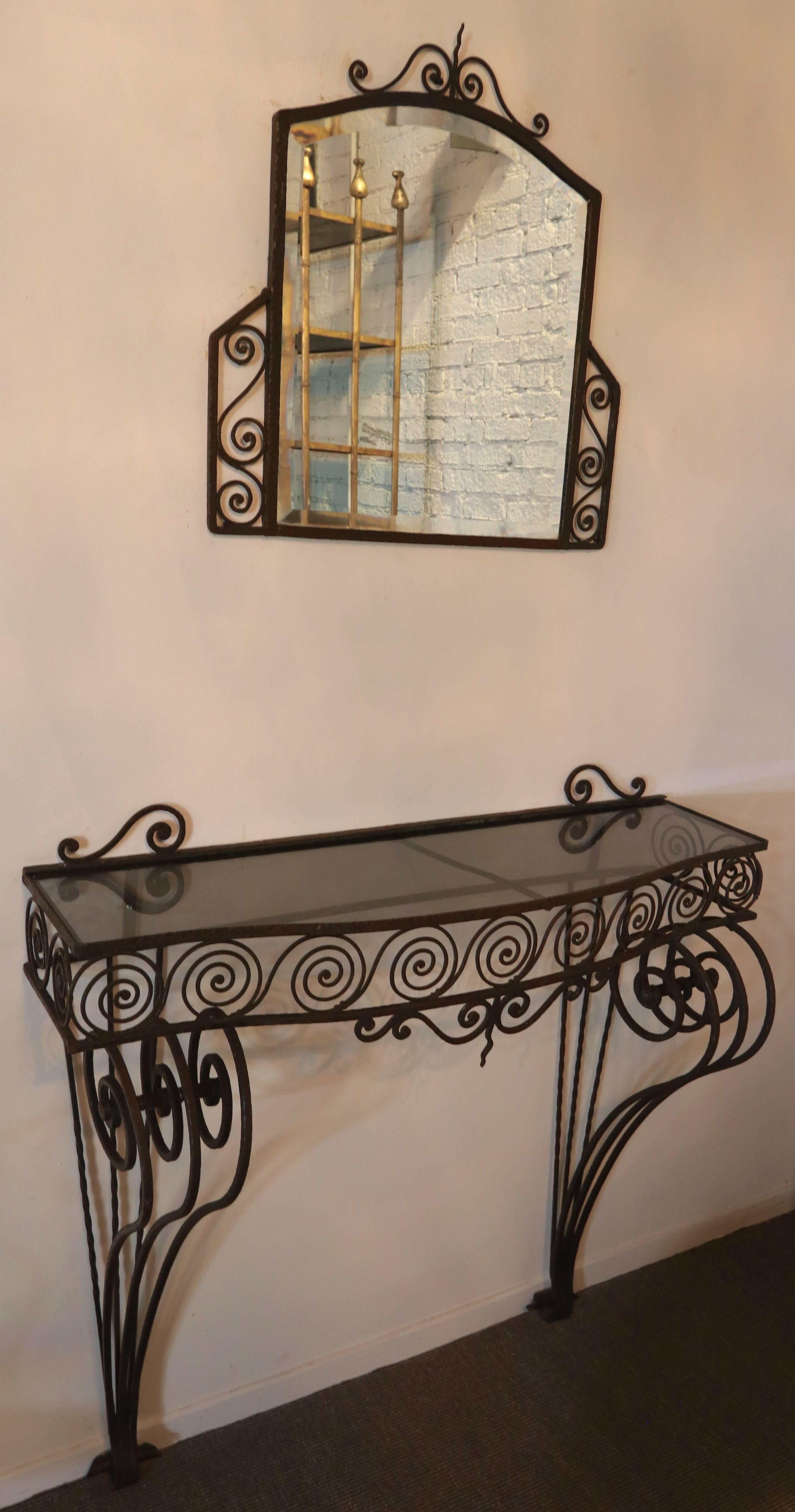 1930s wrought iron console with glass top and matching mirror.