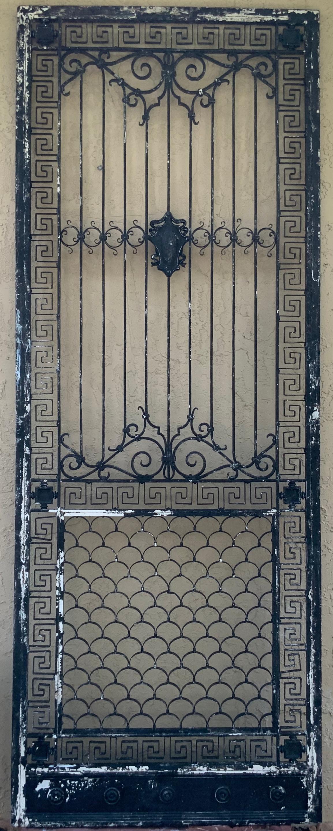 Exceptional iron door with artistic metalwork ,surrounded by beautiful Greek-key motifs this door has history as we acquire it and inspect it ,it was originally part of a gate ,then later added six legs and become coffee table , later in time the