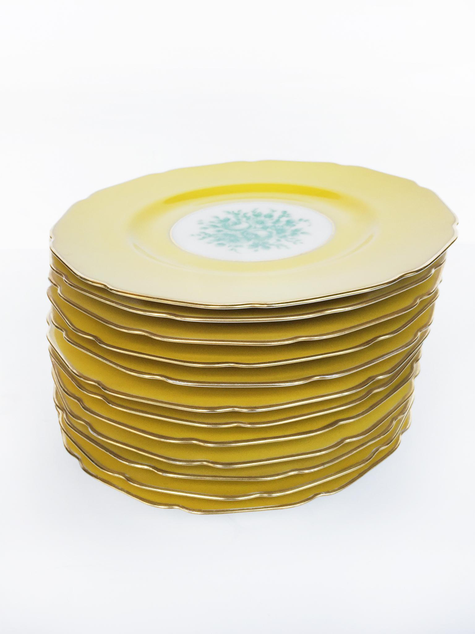 This set of yellow porcelain china consists of 12 dinner plates with two added bread-and-butter plates. The plates were manufactured by Black Knight in the 1930s in Germany and distributed in the United States. They are a gorgeous sunflower-yellow