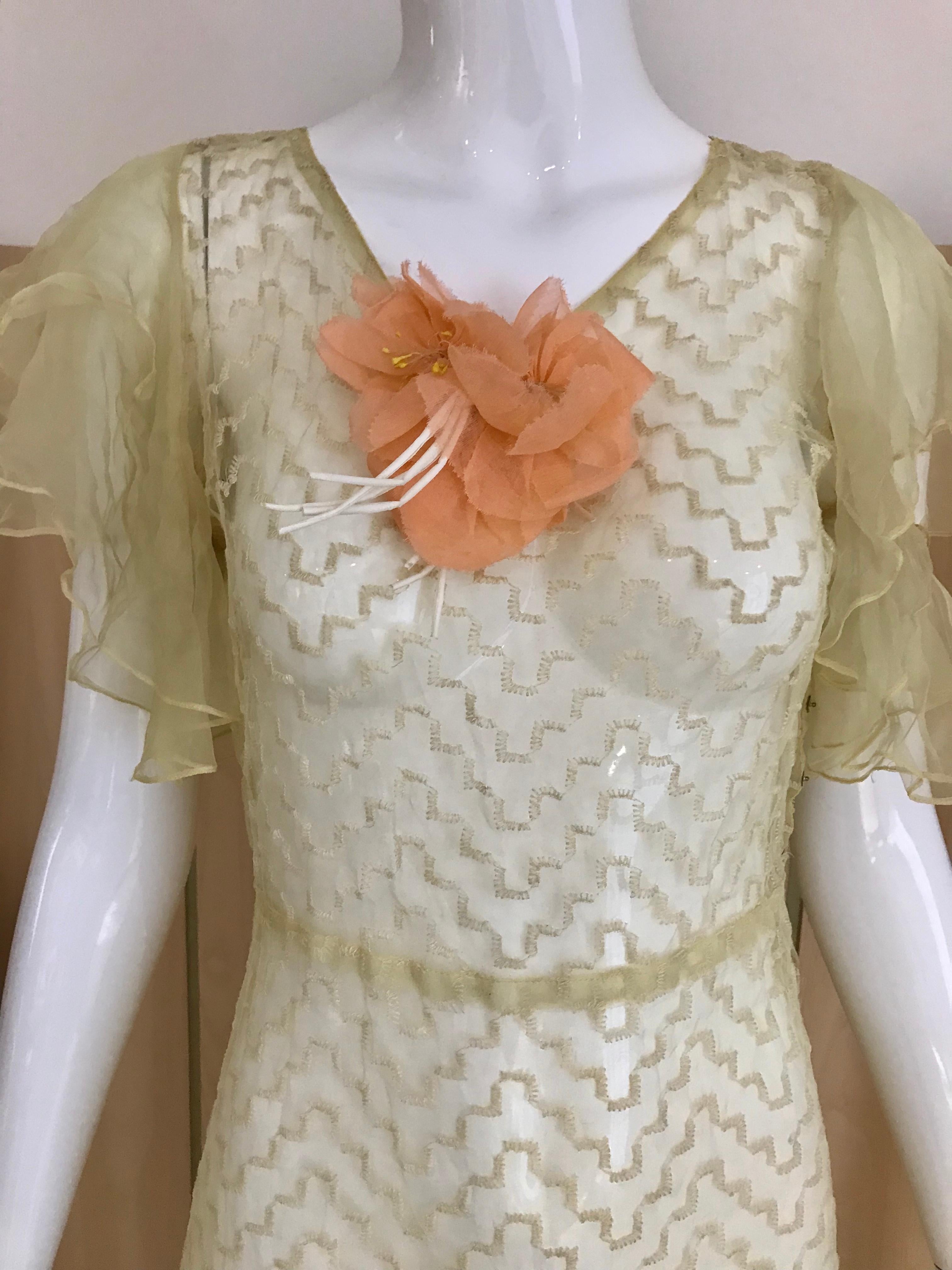 Beautiful Sheer Yellow silk dress with orange silk flower appliqué.
Fit size: 4