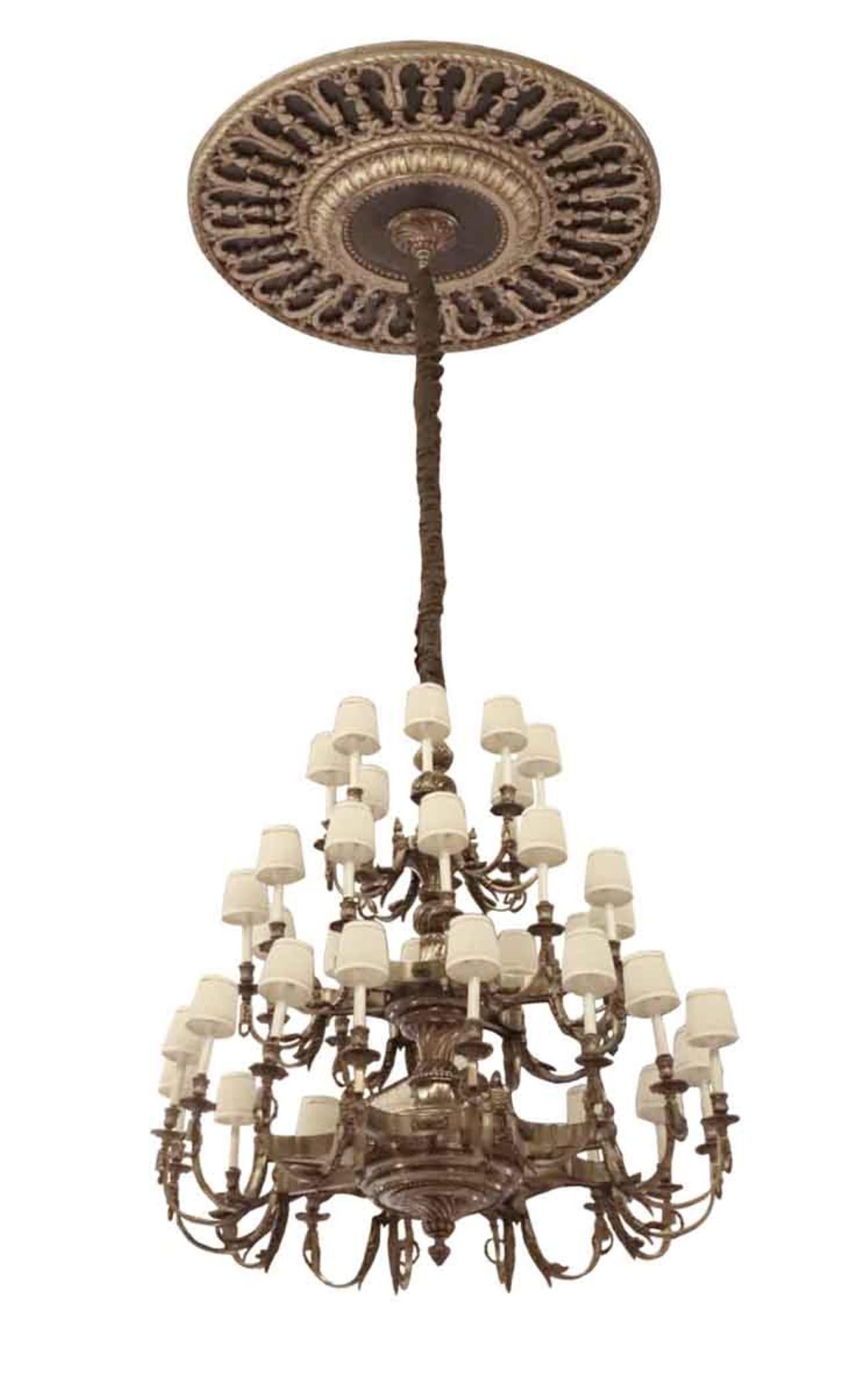 The bronze ceiling medallion not available as it was not retrieved. This 20th century grand scale chandelier originally graced the Conrad Suite in the Waldorf Astoria Hotel in NYC. This bronze chandelier has 36 lights and can be used with or without