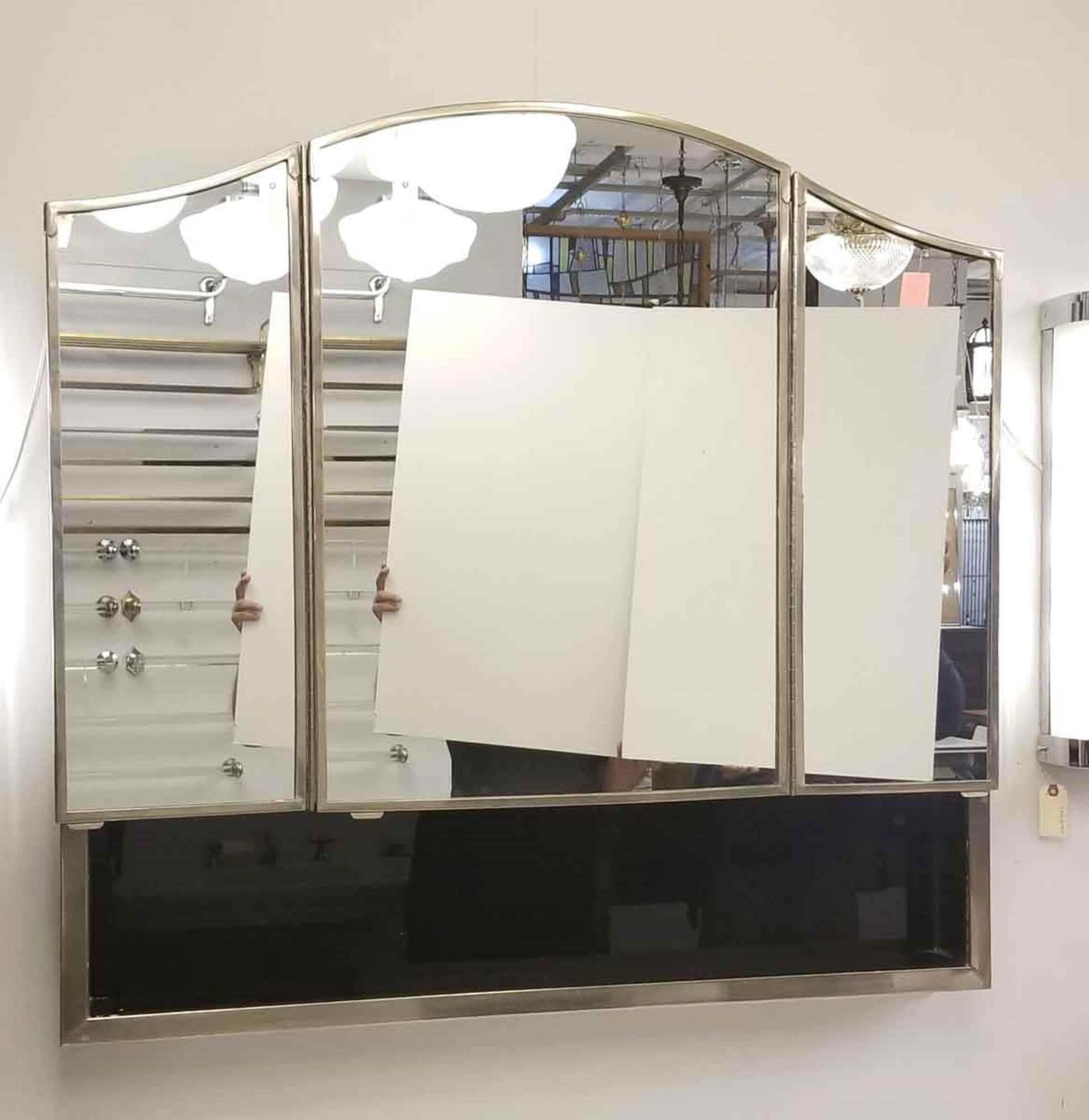 This three section recessed medicine vanity bath cabinet once graced a bathroom in the prestigious 1931 NYC Waldorf Astoria Hotel Towers. The three doors open for a tri-view, with a recessed cabinet behind each door, and two glass shelves in each