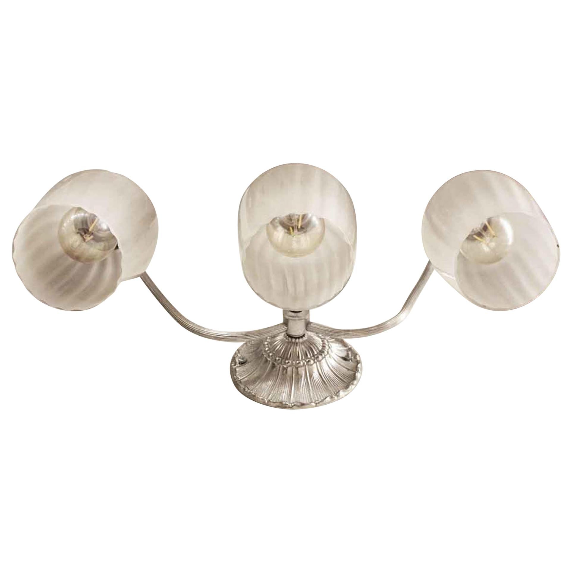 20th Century nickel over heavy cast brass and nickel plated wall sconce with foliage detail and three Italian glass shades. These sconces adorned the powder rooms of the towers of the NYC Waldorf Astoria Hotel. Priced each. Waldorf Astoria