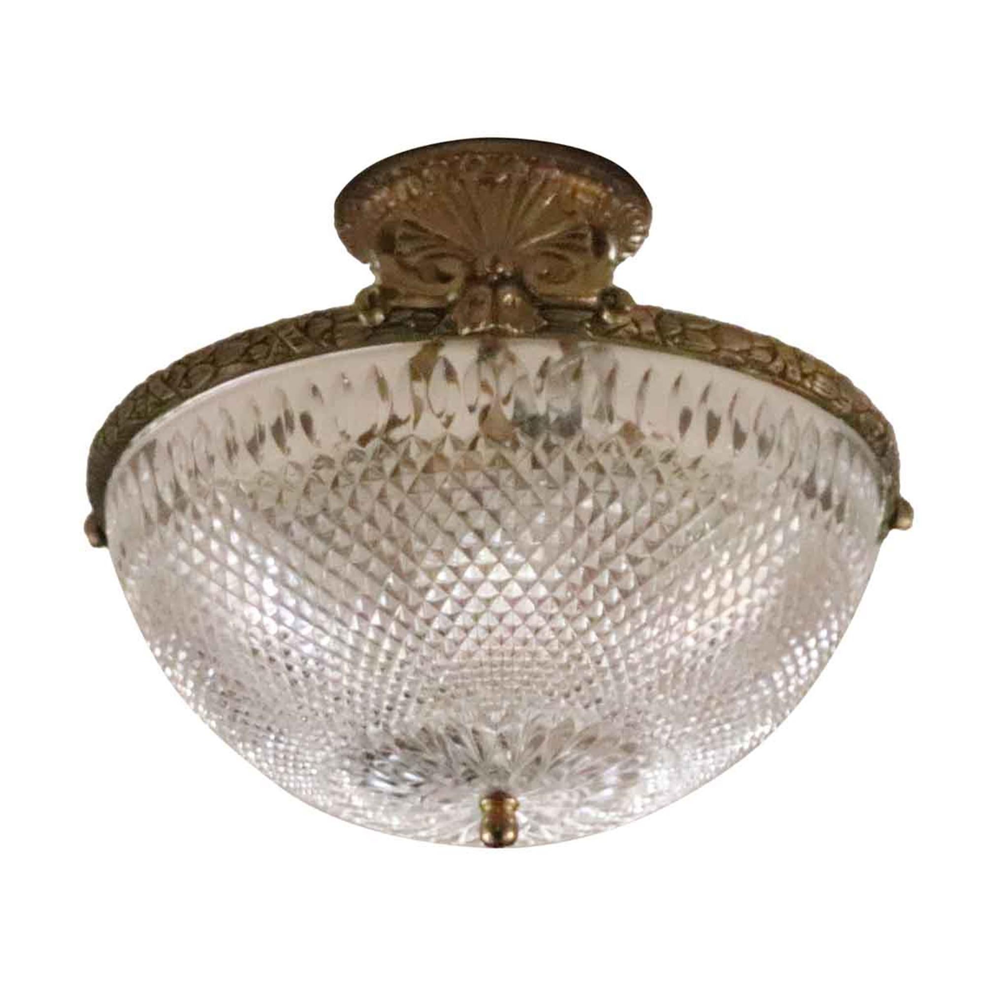 Elegant 1931 semi flush crystal ceiling light with a decorative cast brass base. This is original to the NYC Waldorf Astoria Hotel. Possible variation in details such as the finial or brass tone. Several available at time of posting. Please inquire.