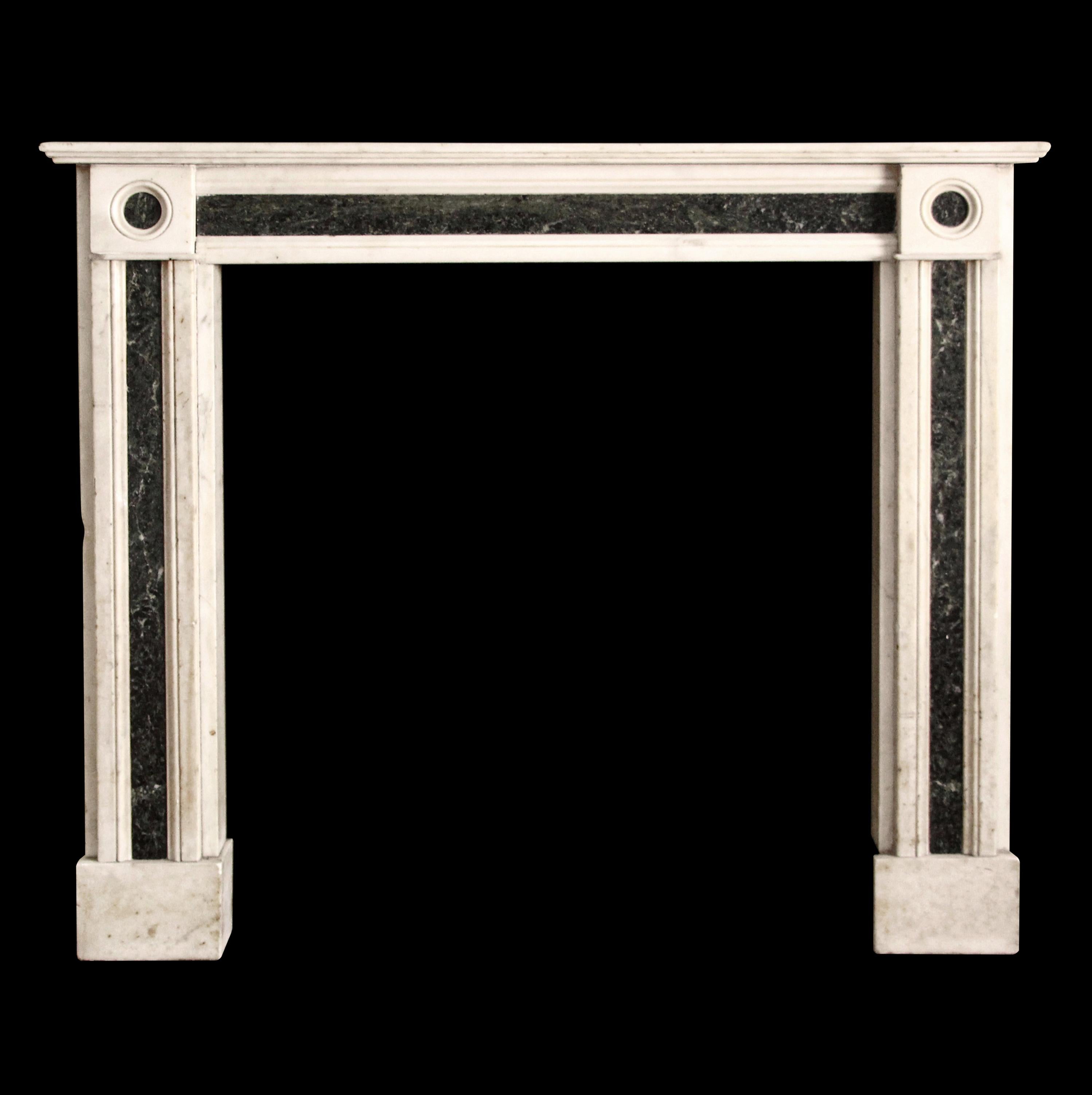 Hearth not included. Early 19th century English Regency marble mantel with deep green inlay. Simple yet decorative rondels grace the pilasters on the top both sides. This mantel was one of a group of antique mantels imported from Europe and
