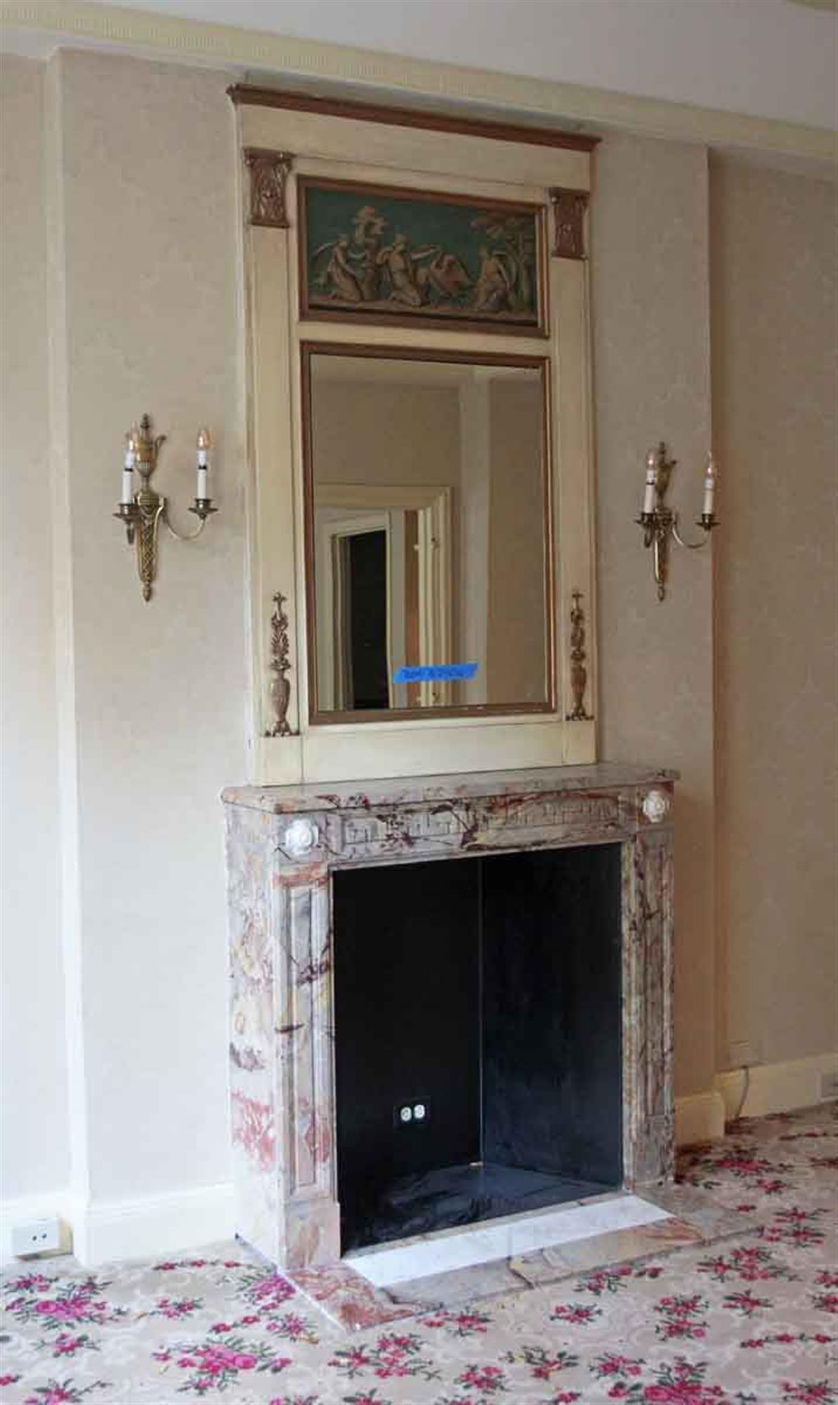 White wood over mantel mirror with decorative carvings and green and gold figural details. From France. Original to Room 700M of the NYC Waldorf Astoria Hotel. Waldorf Astoria authenticity card included with your purchase. This can be seen at our
