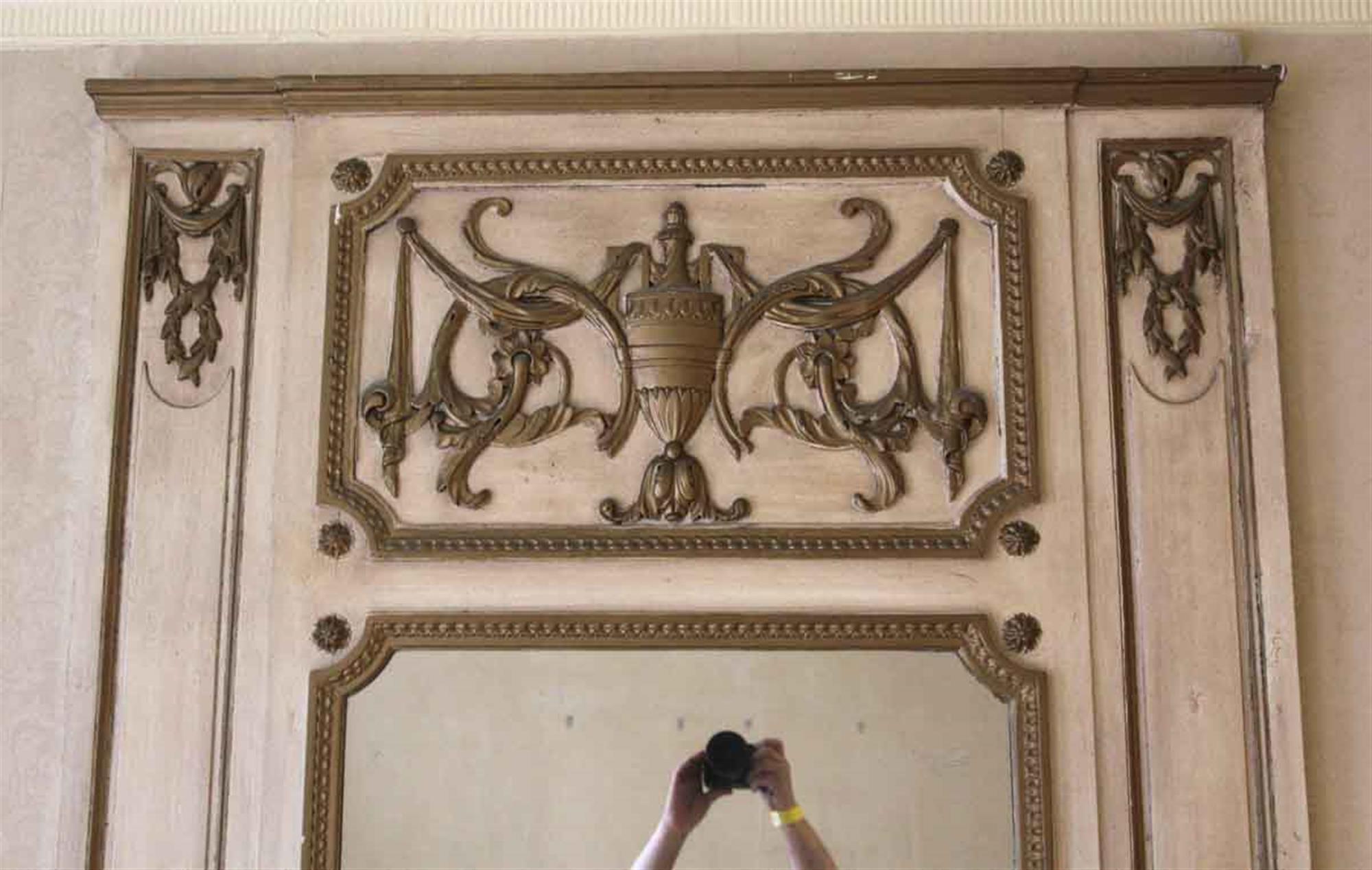 Decorative off white wooden over mantel mirror with carved details and an urn in the top center from 1931. Original to Room 865 of the NYC Waldorf Astoria Hotel. Waldorf Astoria authenticity card included with your purchase. Please note, this item