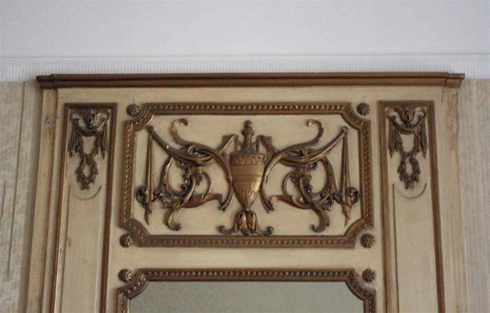 1931 NYC Waldorf Astoria Hotel tan wood over mantel mirror with carved golden brown details and a large urn in the top centre. From room 765. The original paired mantel is not available. Waldorf Astoria authenticity card included with your purchase.