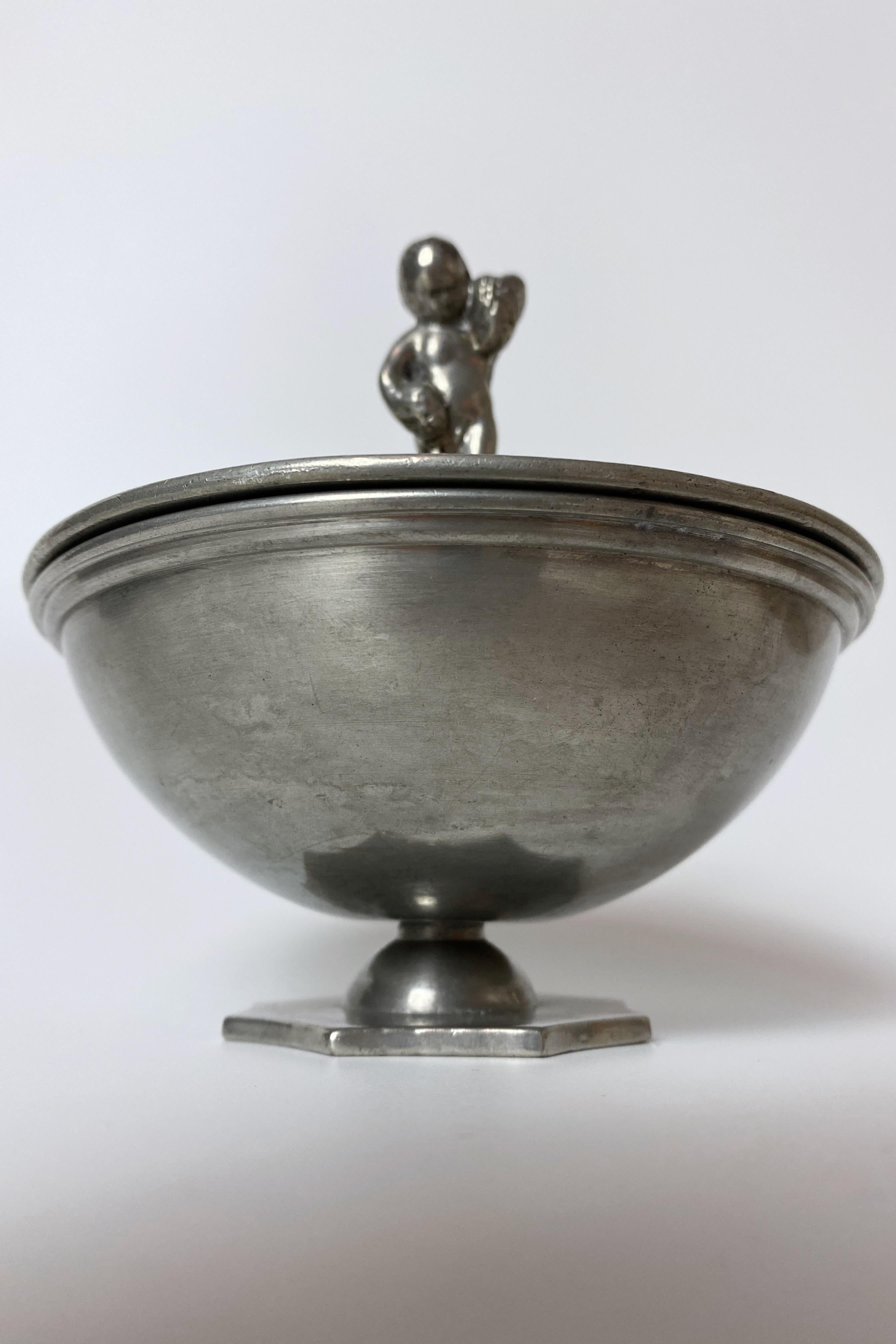 Lovely Swedish Pewter bowl by GAB, Sweden, from 1931. Octagon shaped fot with a rounded bottom and flat lid with a figurine on the top. A great example of the Swedish Grace period with neo classic influences. Age appropriate wear to the