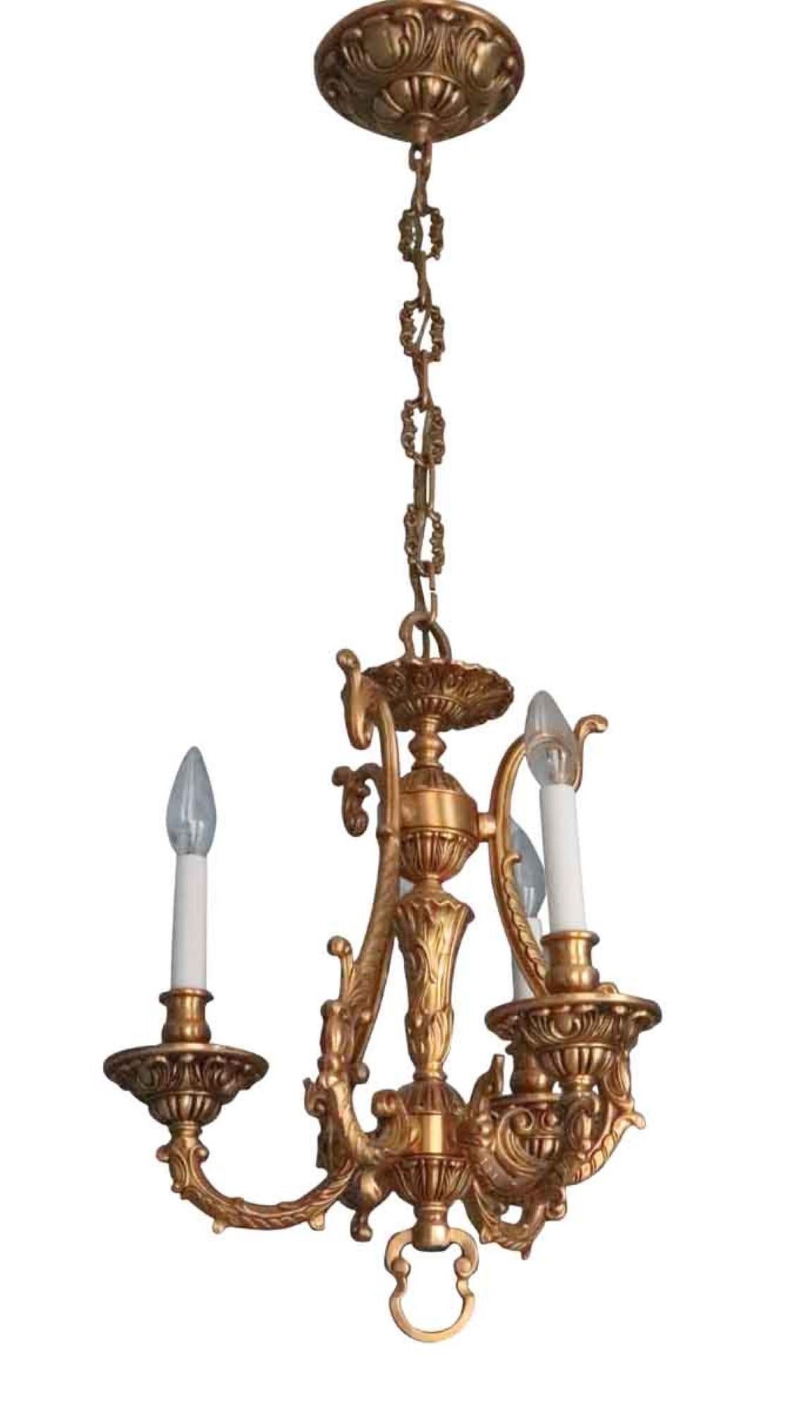 This small and elegant three light cast brass fixture has a copper plated finish. This light manufactured in the 20th century is one that was original to the 36th and 37th floors of the Waldorf Astoria Towers. Two available. Priced each. Price