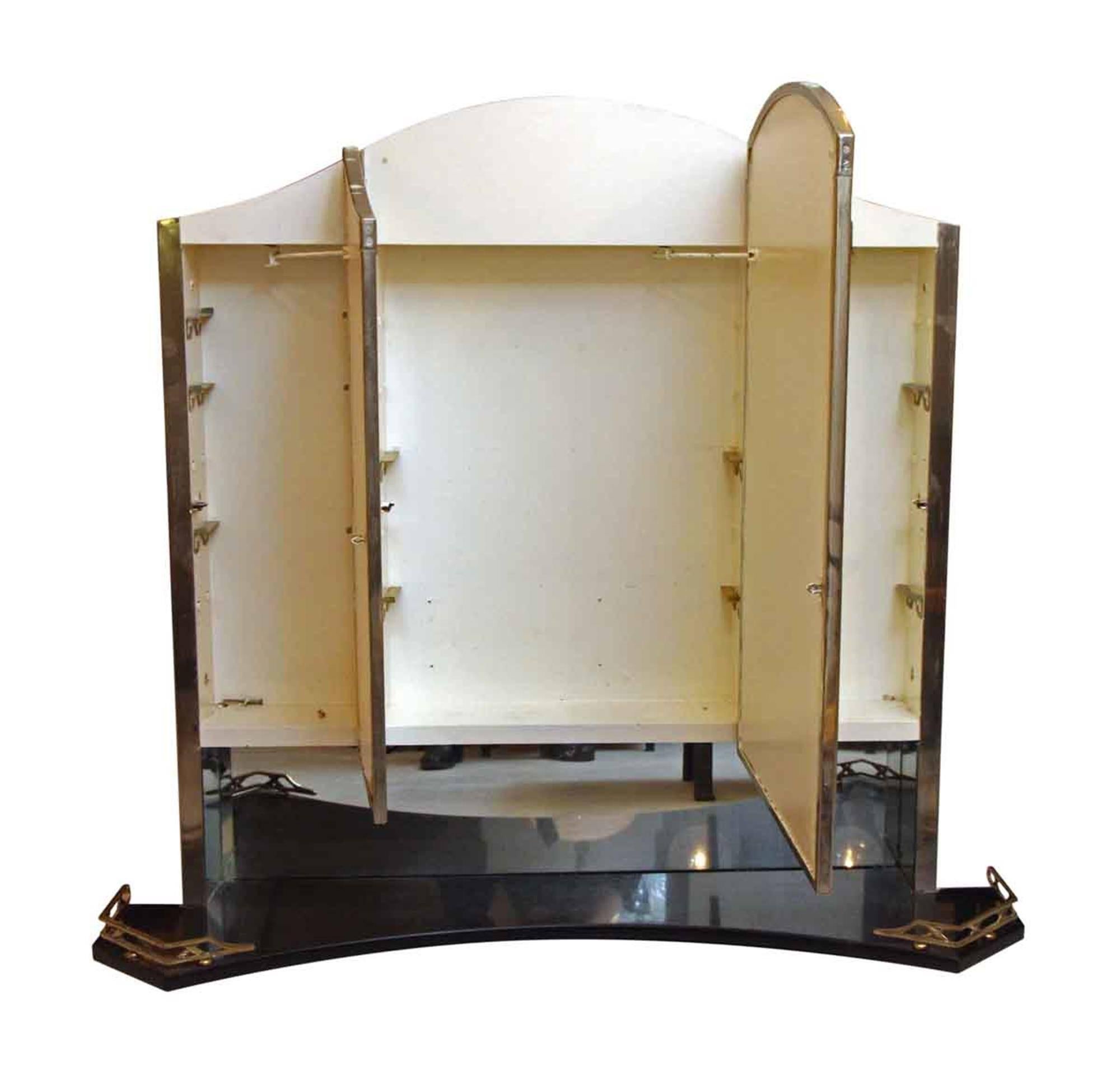 These medicine cabinets are exclusively from the original design of the Waldorf Astoria Hotel, circa 1931. The frame is nickel over cast brass with the original mirror still intact and in good condition. There is one main mirror with two side