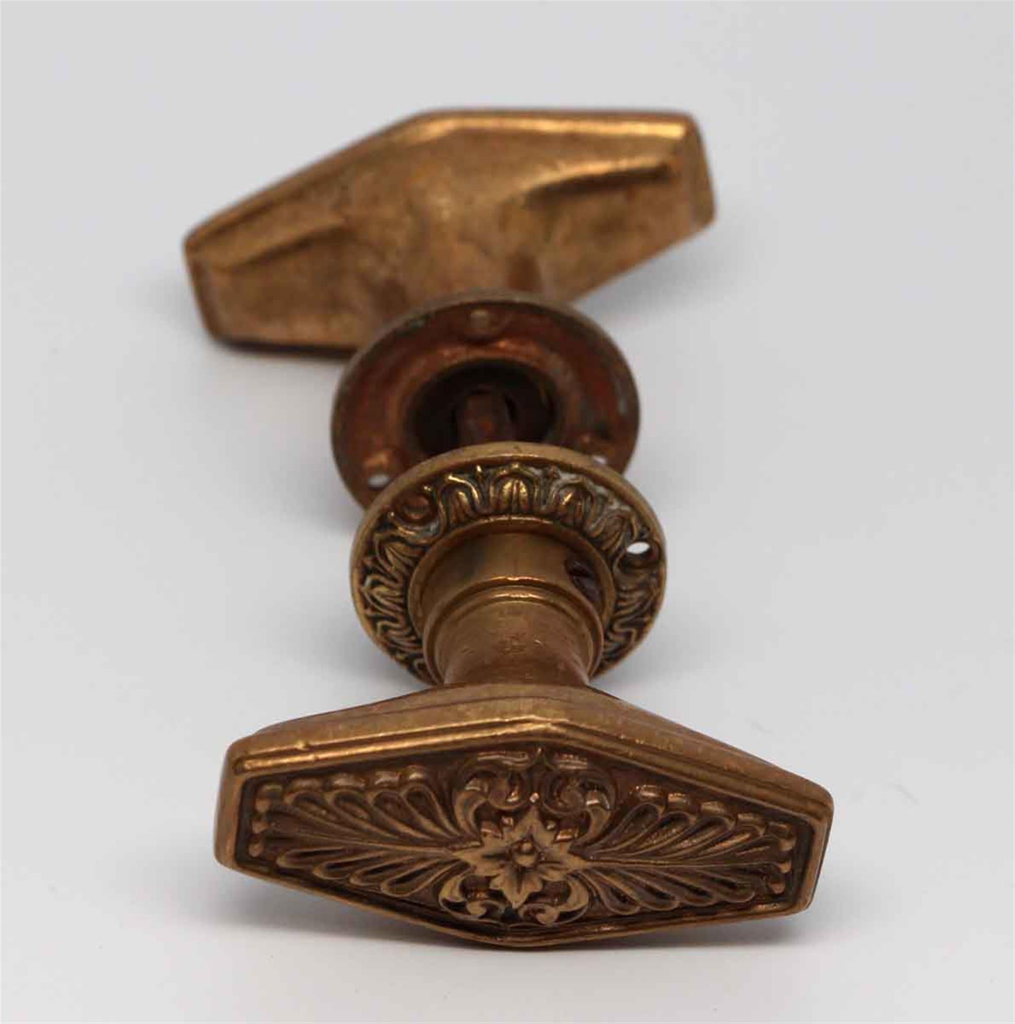 Two fold oval bronze doorknob set made by Russell & Erwin. In their 1931 catalog labeled part of the N-10400 group. This is a special design for the Waldorf Astoria Hotel in New York City. Set includes two knobs with a spindle and two rosettes.