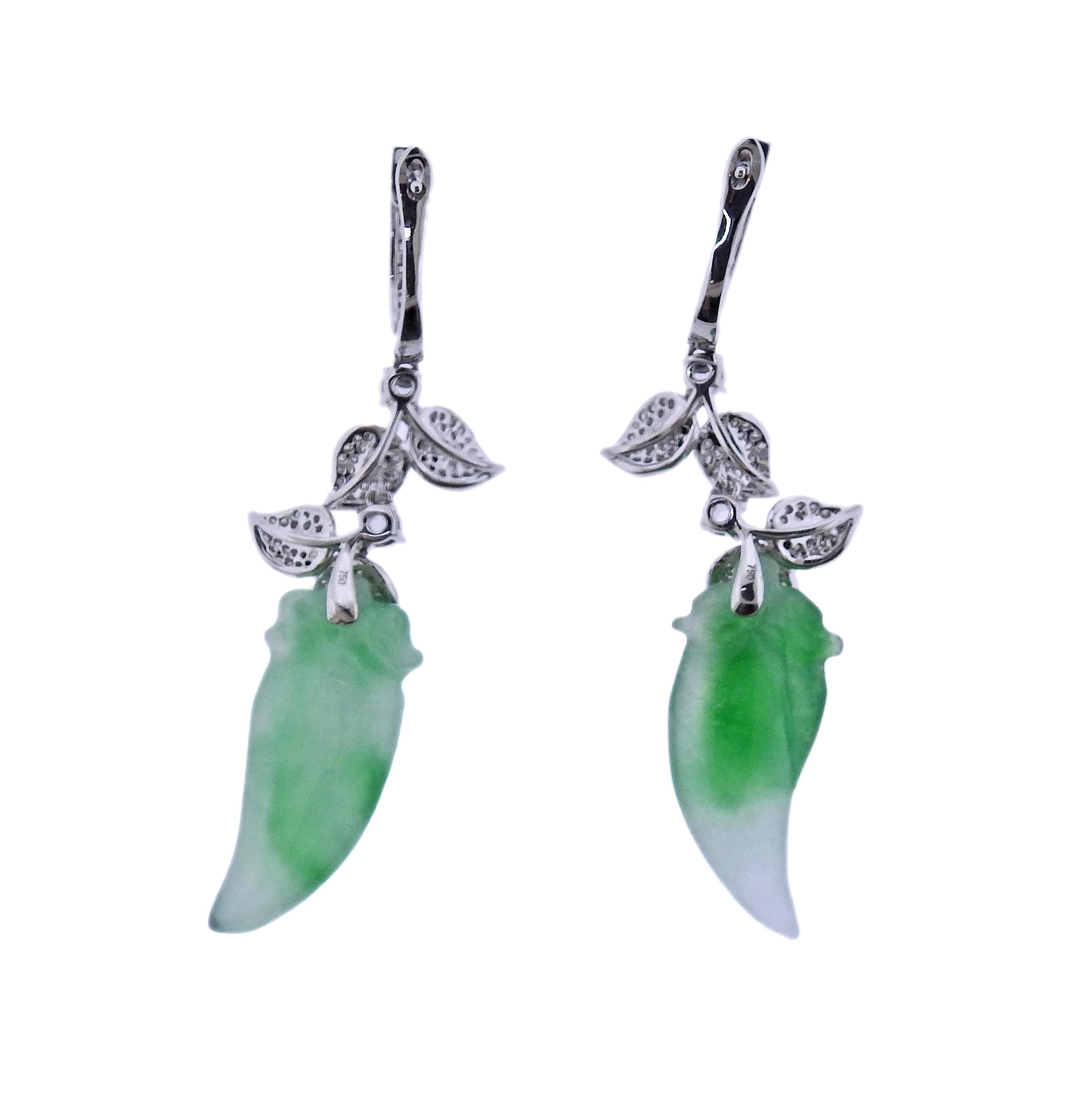 Pair of 18k gold drop earring, with 19.31ctw carved jadeite jade, and 0.81ctw diamonds. Earrings are 51mm long. Marked 750. Weight - 10.1 grams.