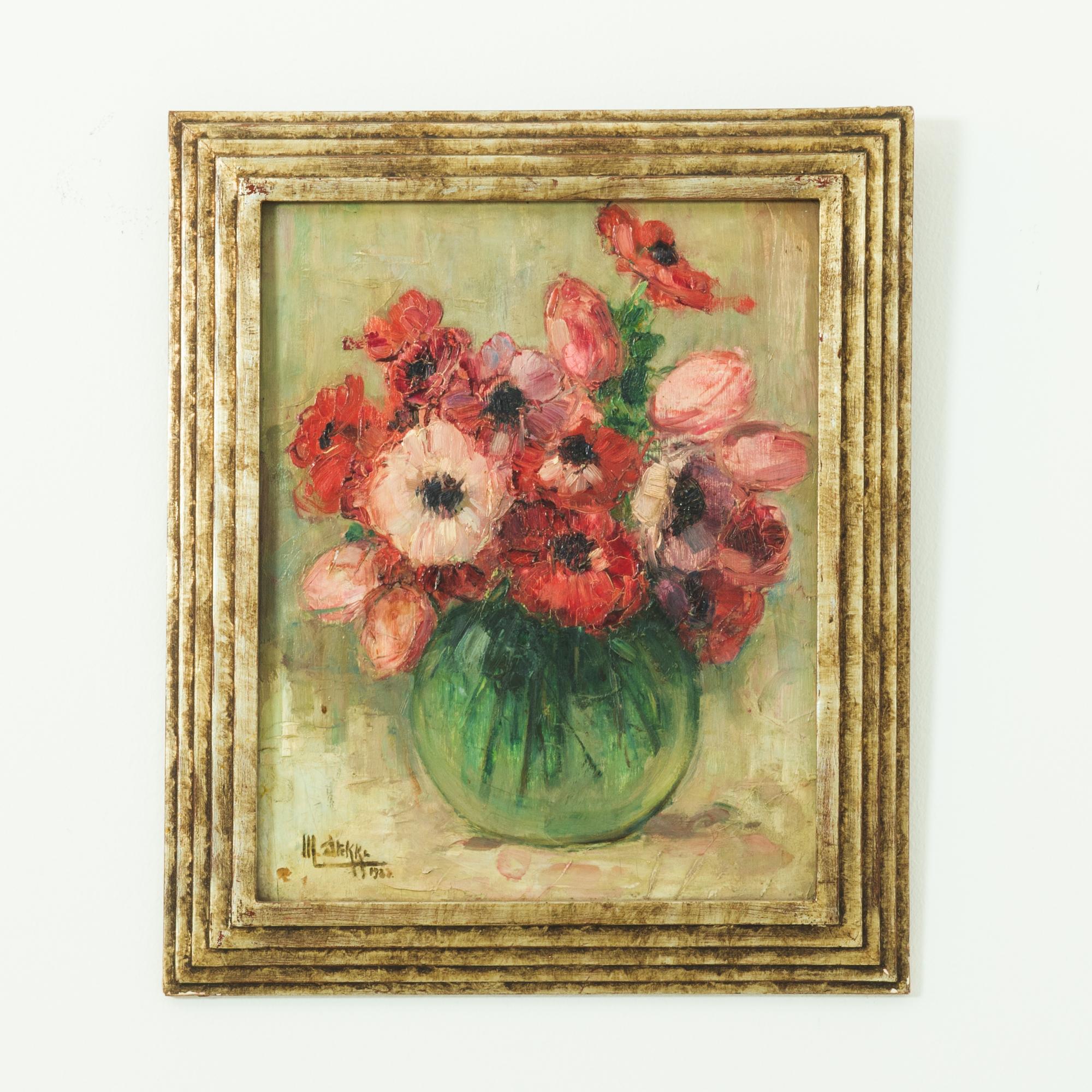 A floral study with gilded frame from France, circa 1880. A still life of tulips in a glass vase is rendered in a thick impasto, signed “M. Arekke” The painting is highlighted by a geometric gilded frame.