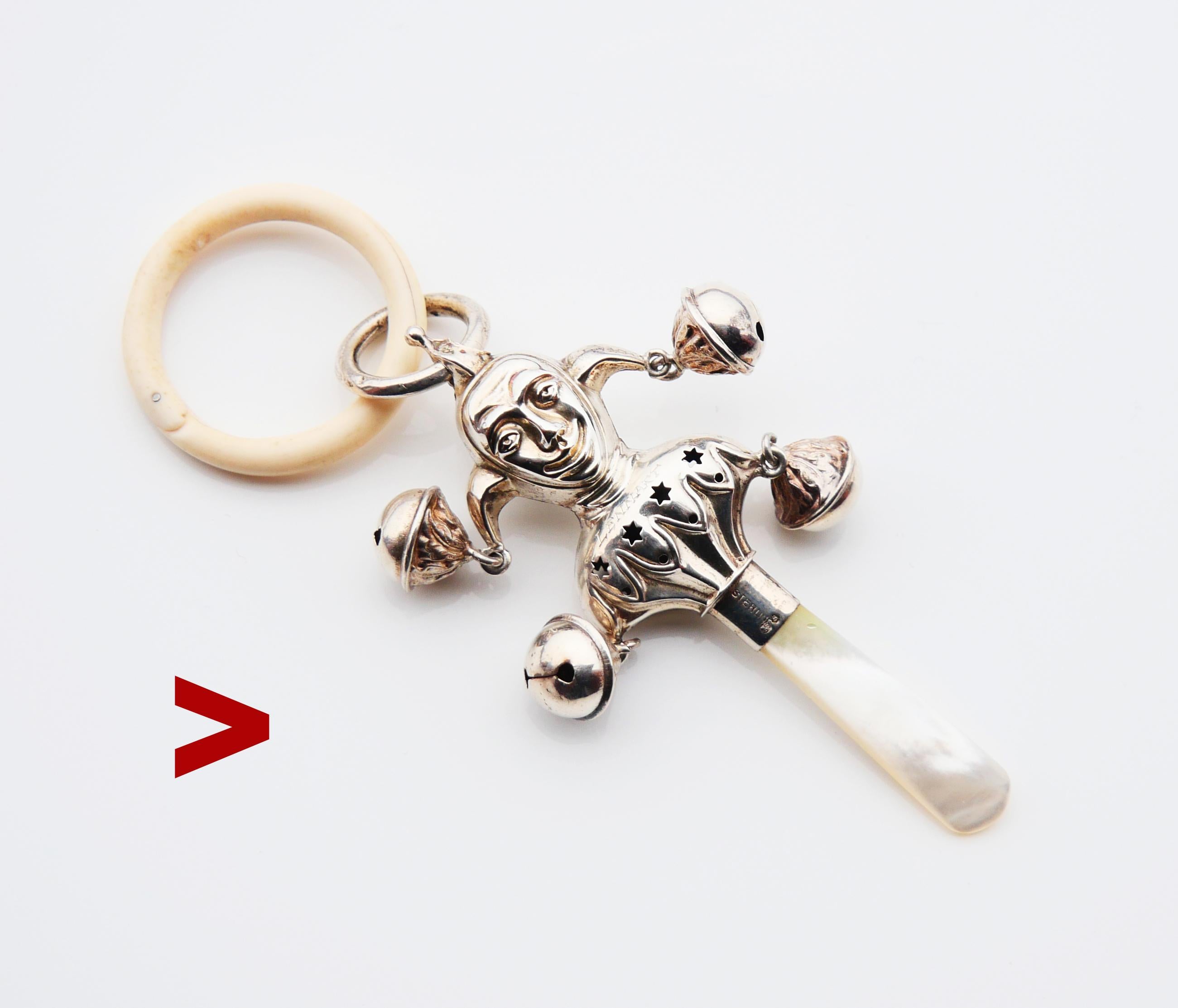 Great Sterling Silver Jocker baby rattle toy, hand - engraved / dated 1932 on one side and named Lennart on the other. This is a toy has four little rattles/bells attached that make a lovely tinkle sound when shook and a mother-of-pearl handle for