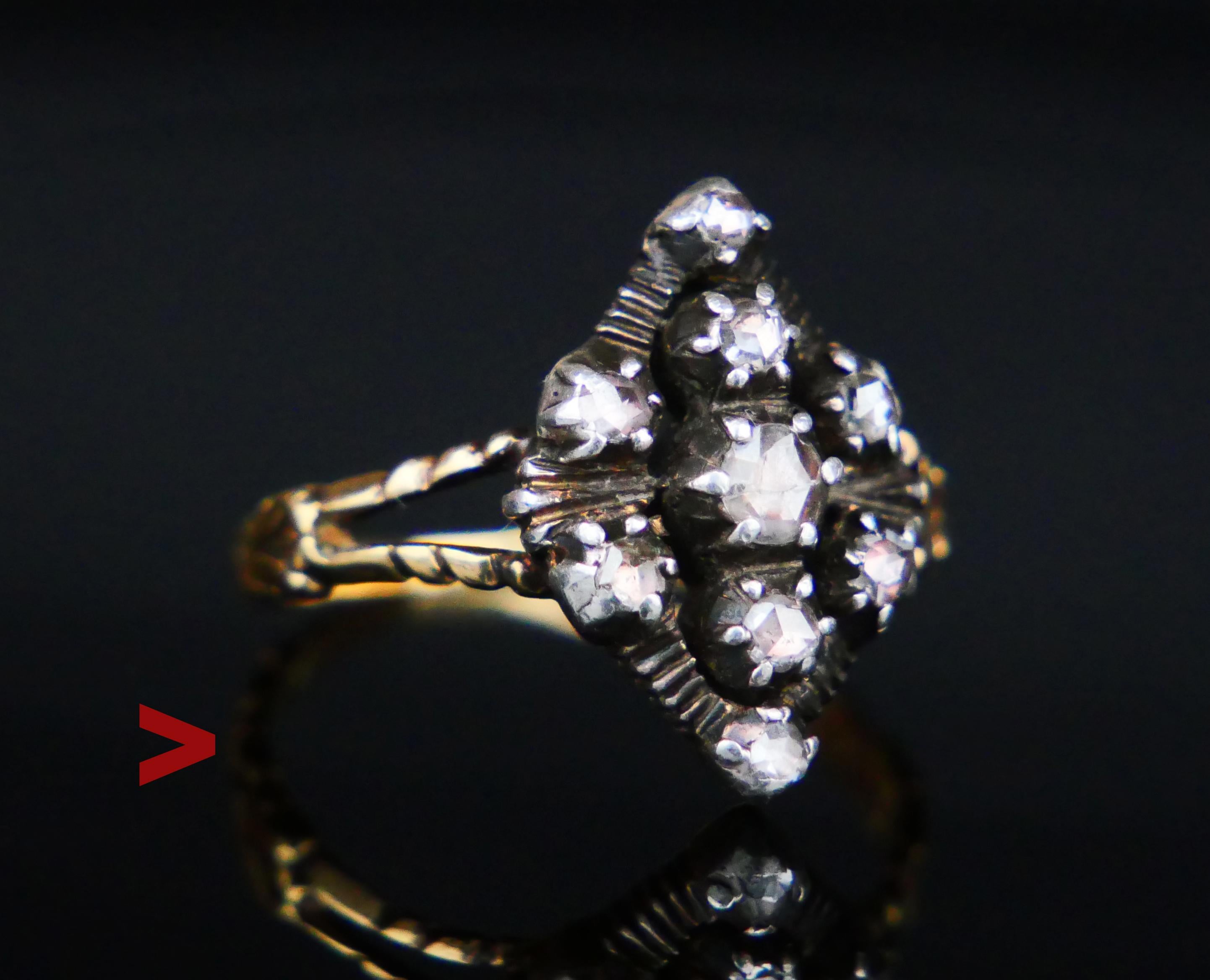 Old Diamond ring with navette or boat shaped openwork crown with Silver clusters melted into solid 18K Yellow Gold base. Nine rose cut Diamonds, central stone is Ø 3mm / ca.0.11ct. All stones with backs closed and foiled under.

Crown measures 16 mm