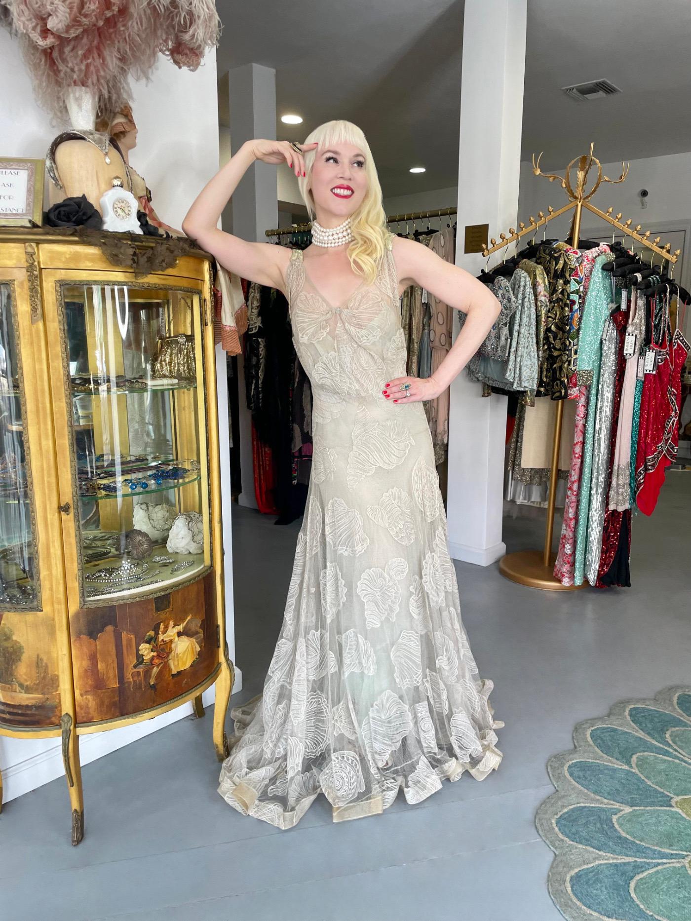 This museum quality, classically gorgeous gown dating back to 1932 spring/summer, was made by the legendary House of Worth. What makes our dress even more significant is that it was a custom couture commission by Elizabeth Arden. The history behind