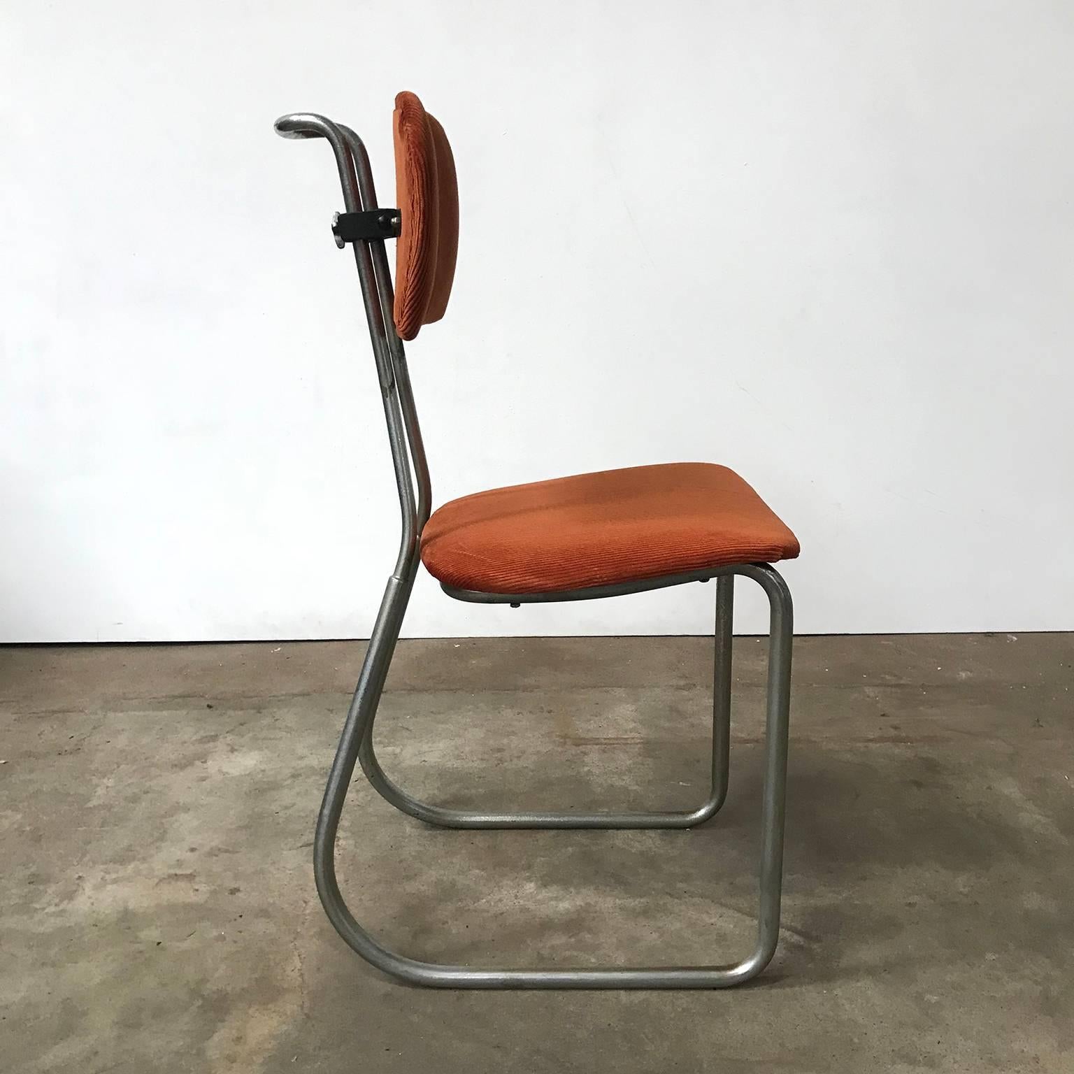 This typing chair in terra brown Manchester upholstery has an elegant chrome base. The seat is not connected to the back. The backrest is adjustable in height as shown on picture #2 and #3. The upholstery is new and in excellent condition. The base