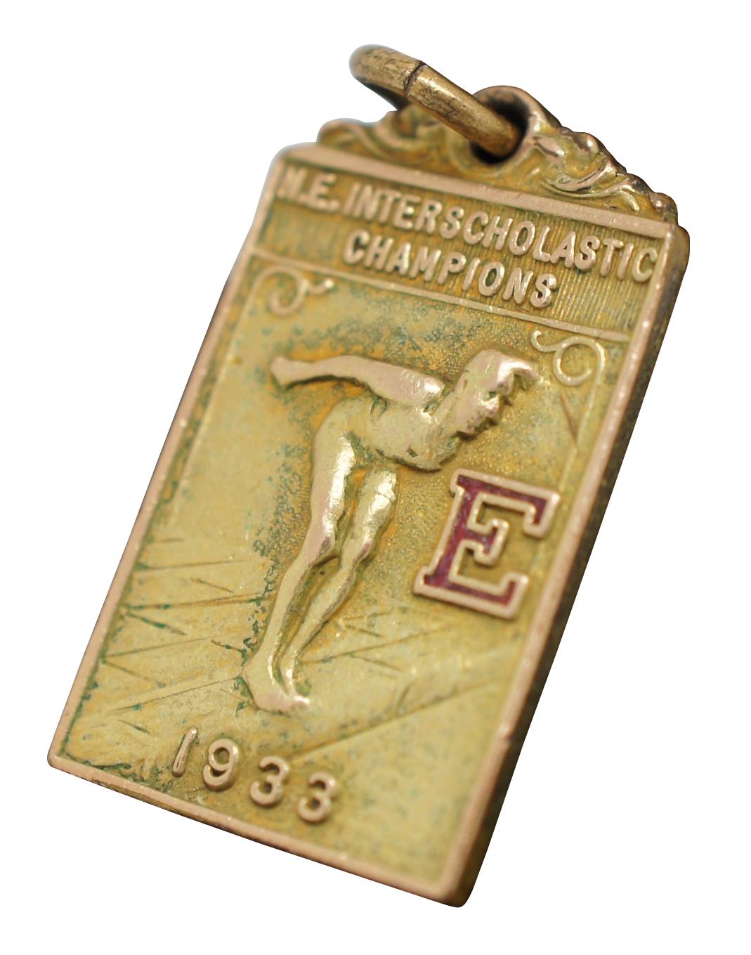 Rare antique 1933 gold filled medal or charm with the words “NE Interscholastic Champions” above a figure prepared to dive into a pool, next to an enameled “E.” Engraved on the back “E-35 A-30 W.S.C.”
