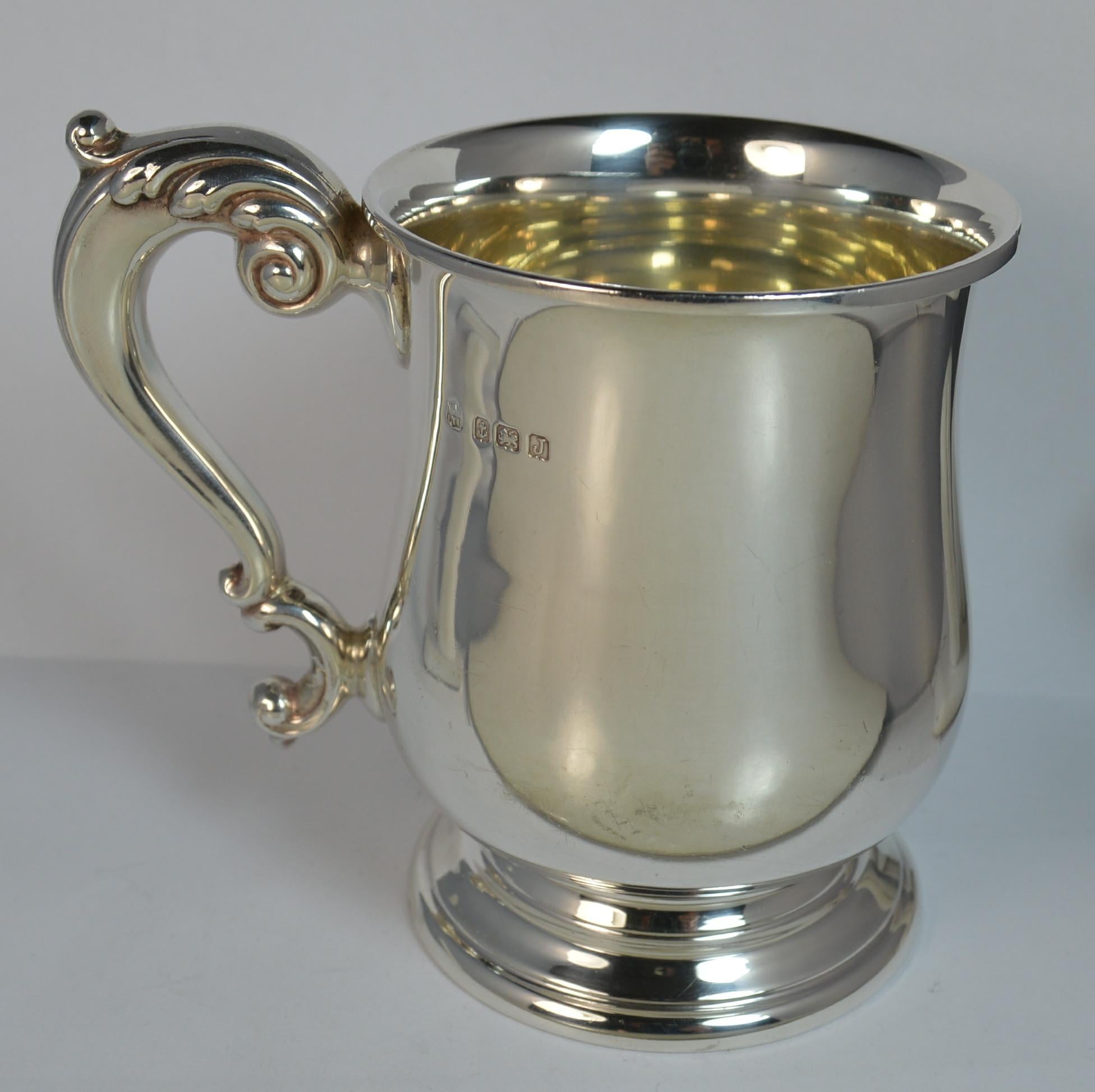 

A beautiful sterling silver Christening cup or mug. Solid heavy gauge of sterling silver. Plain bulbous shape to the tankard with floral handle.

Hallmarks ; lion, Birmingham assay, date letter J, makers marks
Weight ; 213.6 grams
Size ; 110mm x