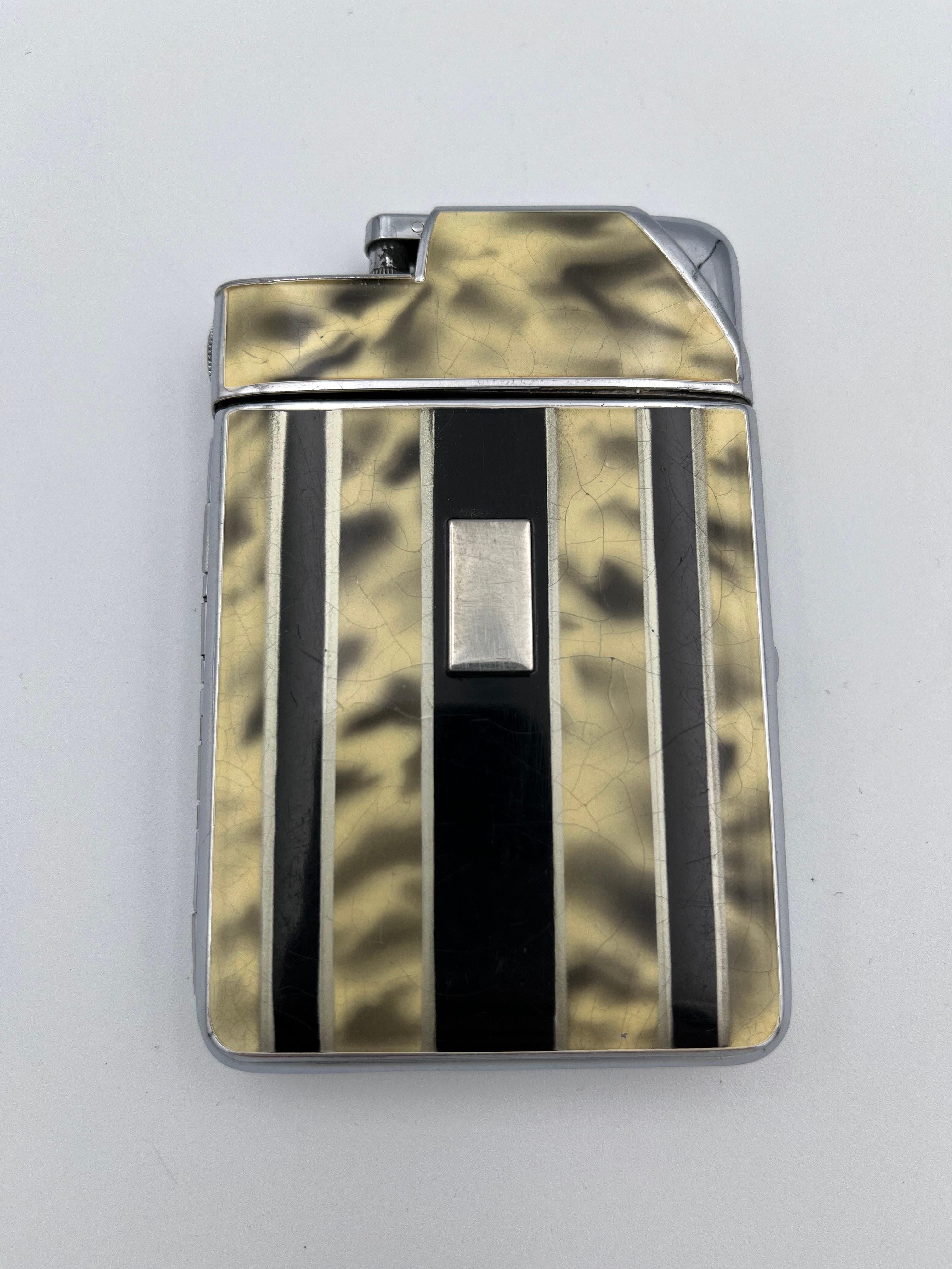 1933 Marathon Art Deco Enamel and Chrome Combination Cigarette Case & Lighter

This rare 1933 Art Deco Marathon cigarette case and lighter is a refined example of Jazz Age elegance and ingenuity. The case features a bold design of vertical black