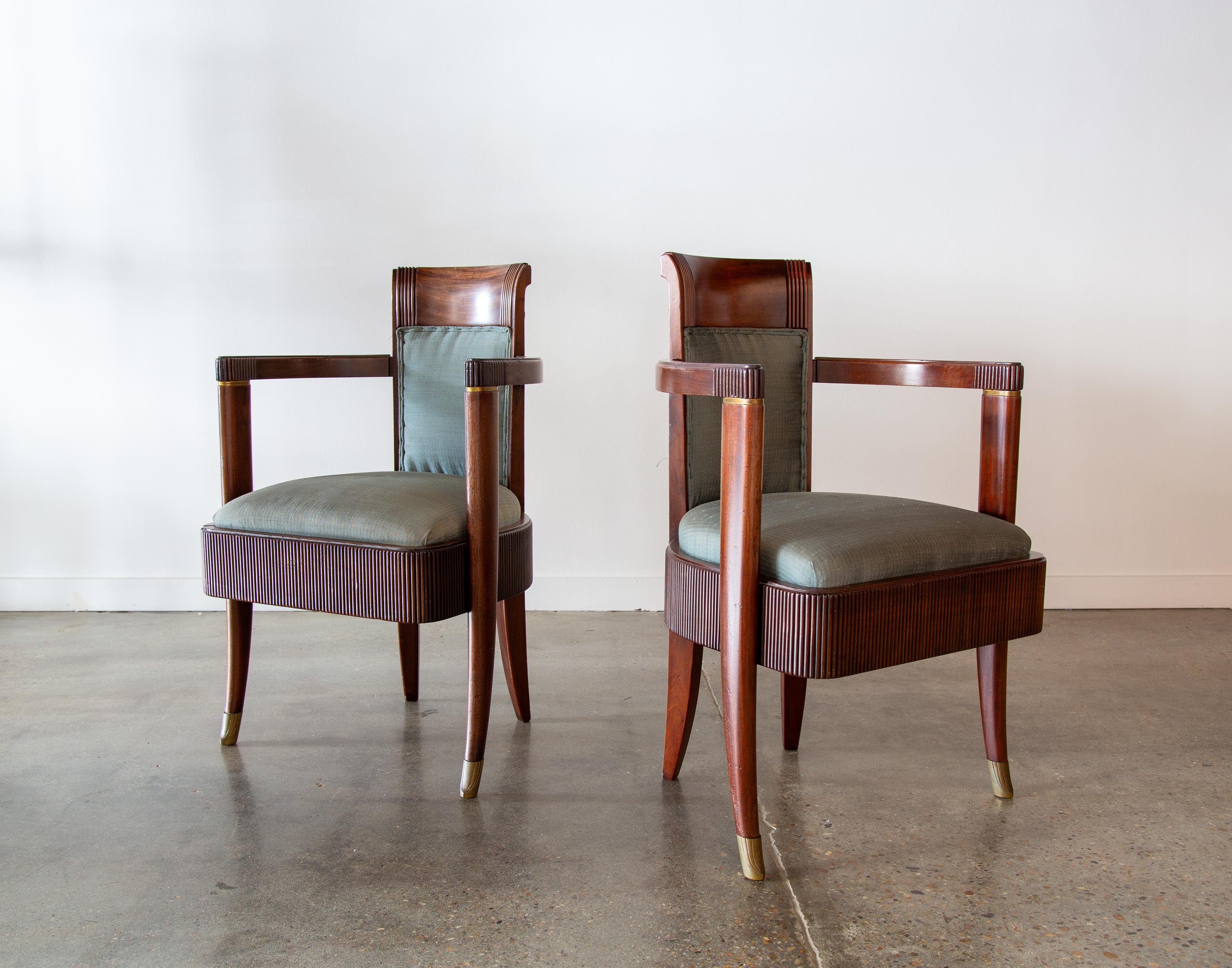 Armchairs from the first class dining room of the SS normandie circa 1934 designed by Pierre Patout. Solid Mahogany with beautiful fluted details around the base of the seat and repeated on the back and arms of the chair. Brass accents are found in