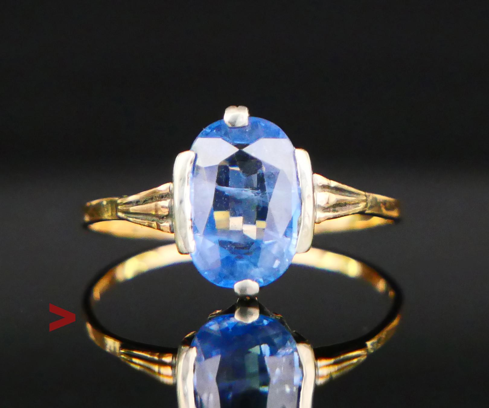 A Ring from the period of my Grandmother's childhood in solid 18K Yellow Gold with a crown in Silver holding natural Cornflower / Light Blue Sapphire of oval diamond cut 10 mm x 7 mm x 3.33 mm / ca. 2.5 ct. Stone demonstrates two spectacular