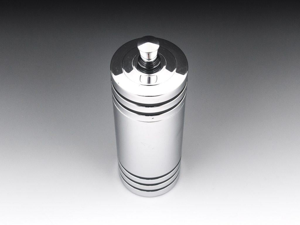 Art Deco American chrome cocktail shaker designed by “Chase”. Simple but striking design with chrome body, black enamel stripes, Bakelite handle with a twist-off top and removable strainer. The American cocktail shaker has a prancing centaur with