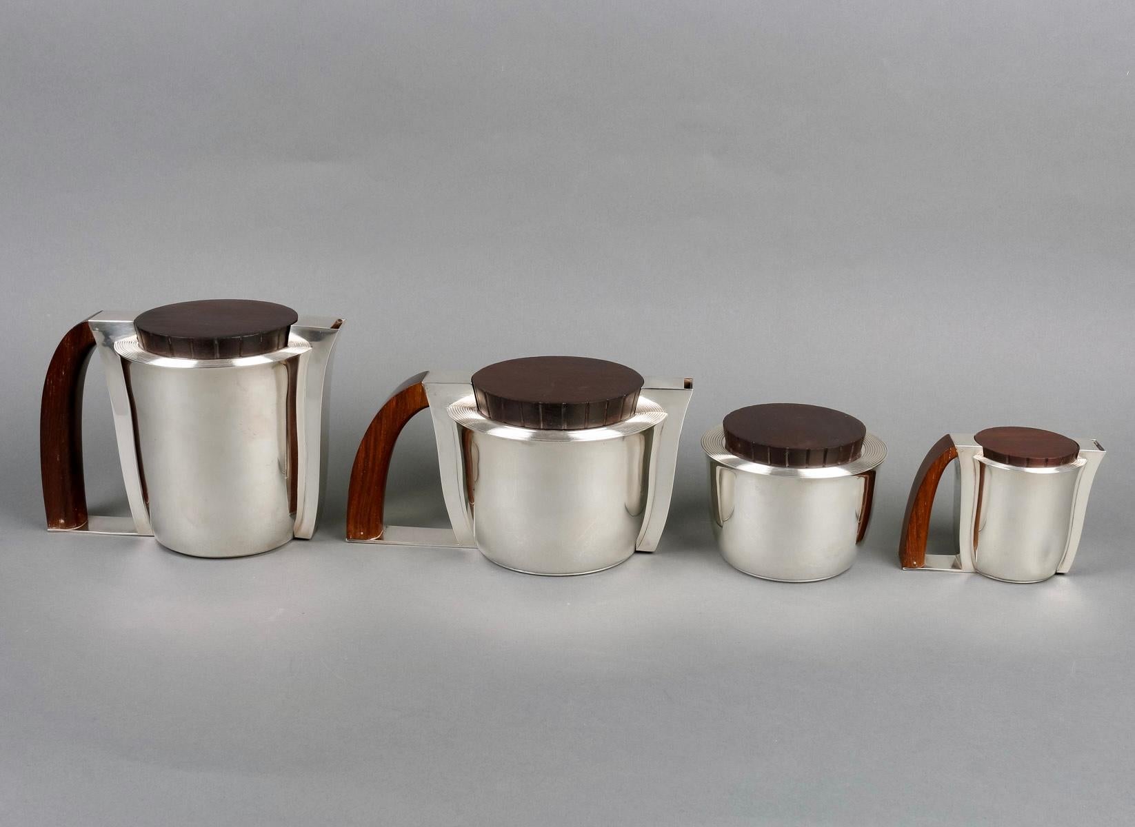 Modernist Art Deco tea and coffee set in sterling pure silver and rosewood by Jean E. Puiforcat created in 1935. 

Service including:
- a coffee pot 
- a teapot
- a milkpot
- a sugar pot

Minerve Solid Silver 950/1000 French mark - maker's stamp on
